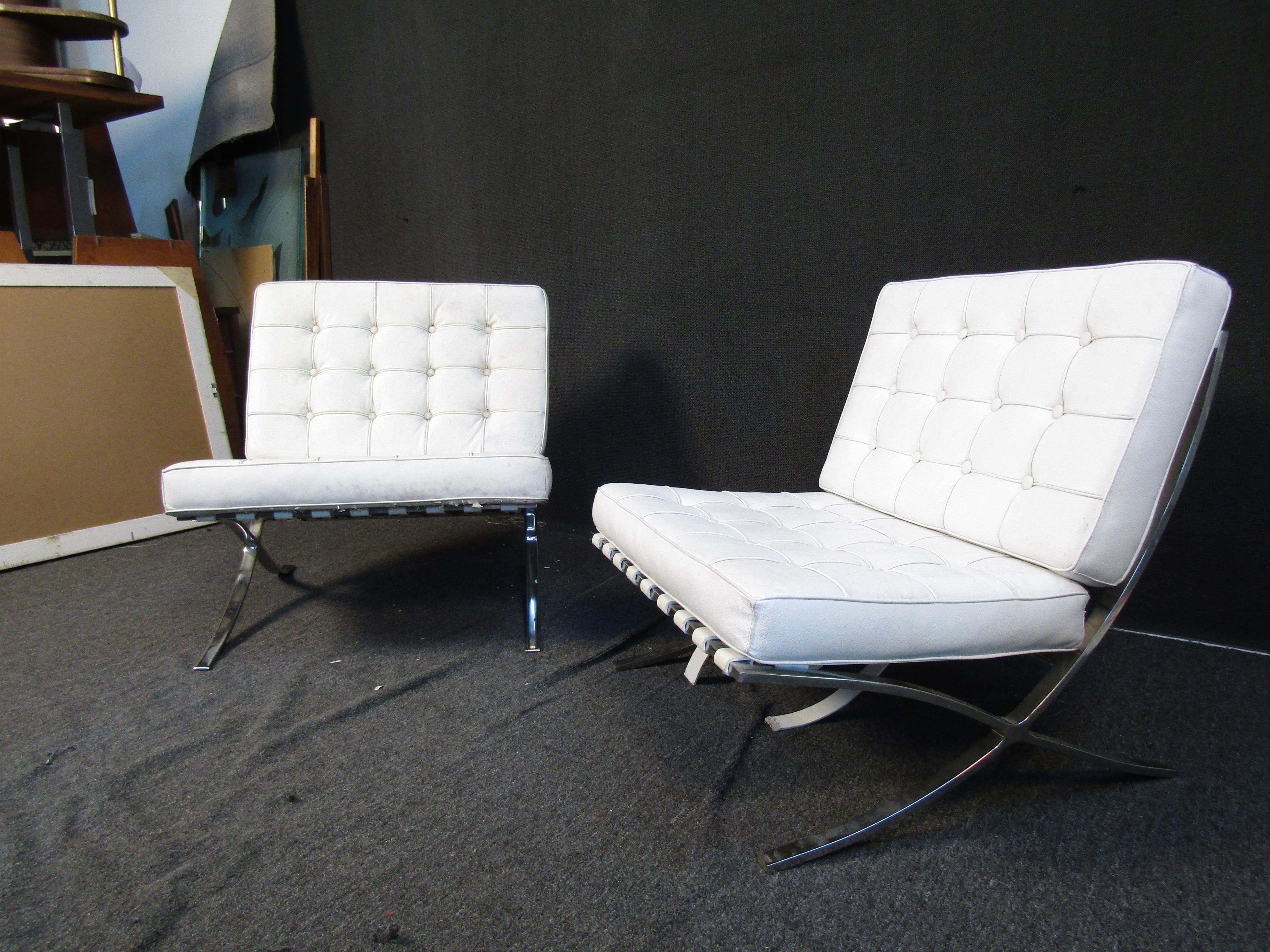 White vinyl upholstery and chrome are paired to elegant effect in this vintage pair of Barcelona style lounge chairs. Please confirm item location with seller (NY/NJ).