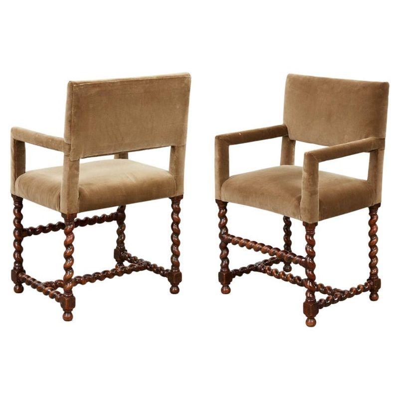 Good pair of 19th Century Baroque style armchairs upholstered in velvet, the square backs over upholstered arm and seats and standing on bold barley twist turned legs joined by similarly turned stretchers. 
 
Seat height: 22
