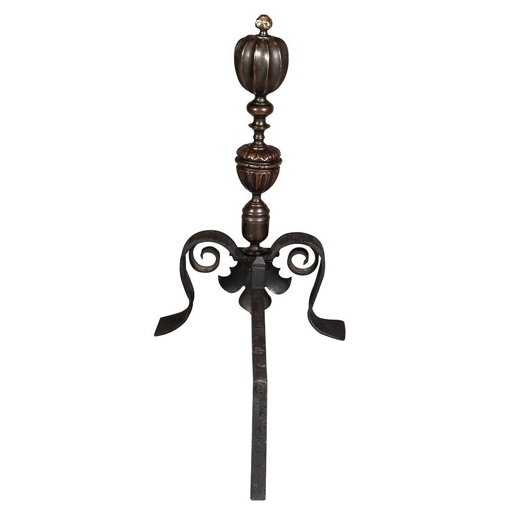 With finials with faces and melon form turned decoration, scroll legs and wrought iron dogs.
