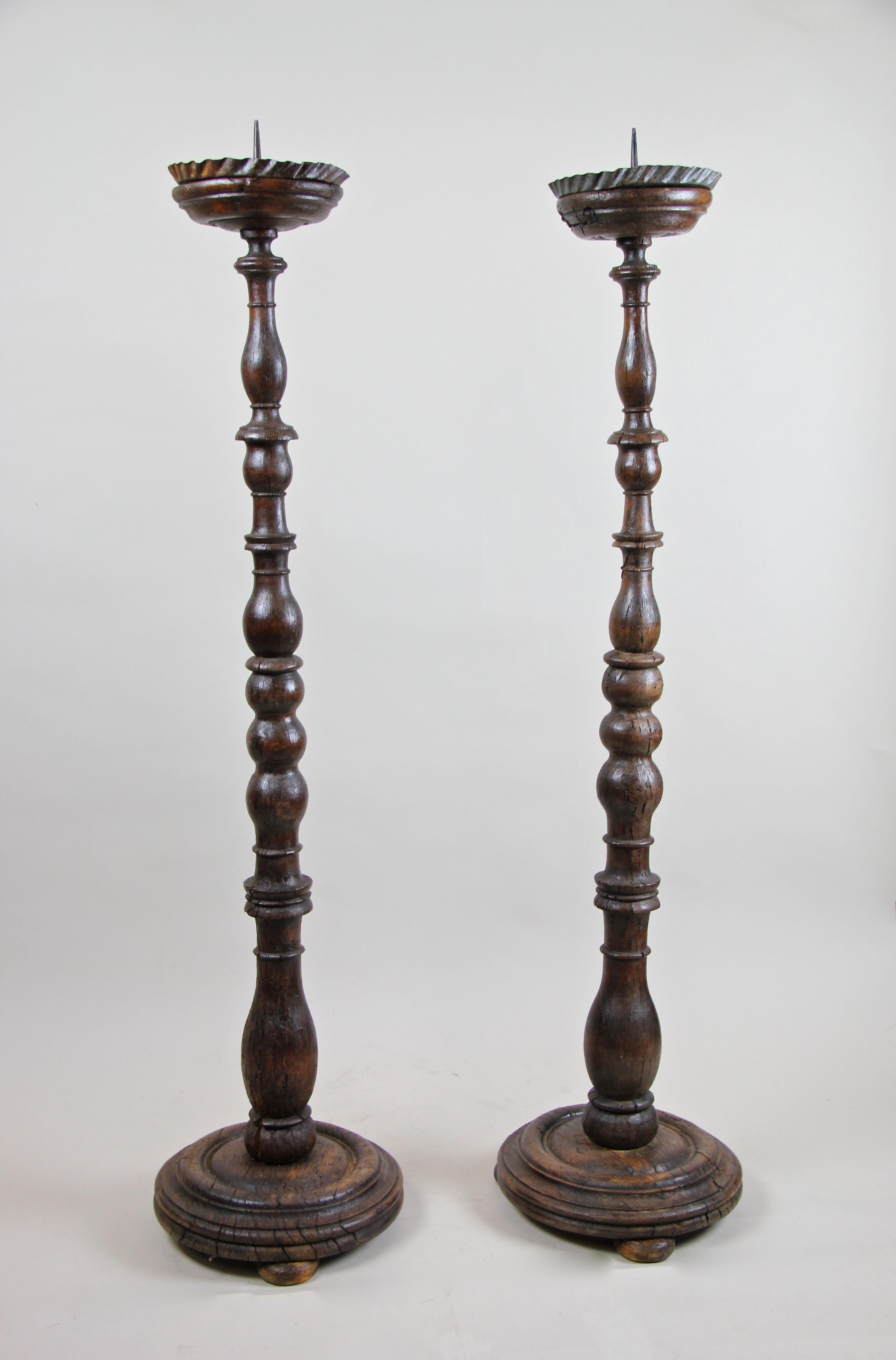 Wonderful rare pair of large Baroque candlesticks from the period circa 1770. Hand carved out of solid oakwood, these nearly 250 year old altar sticks come in great original condition, showing different stress cracks and inactive wormholes. But
