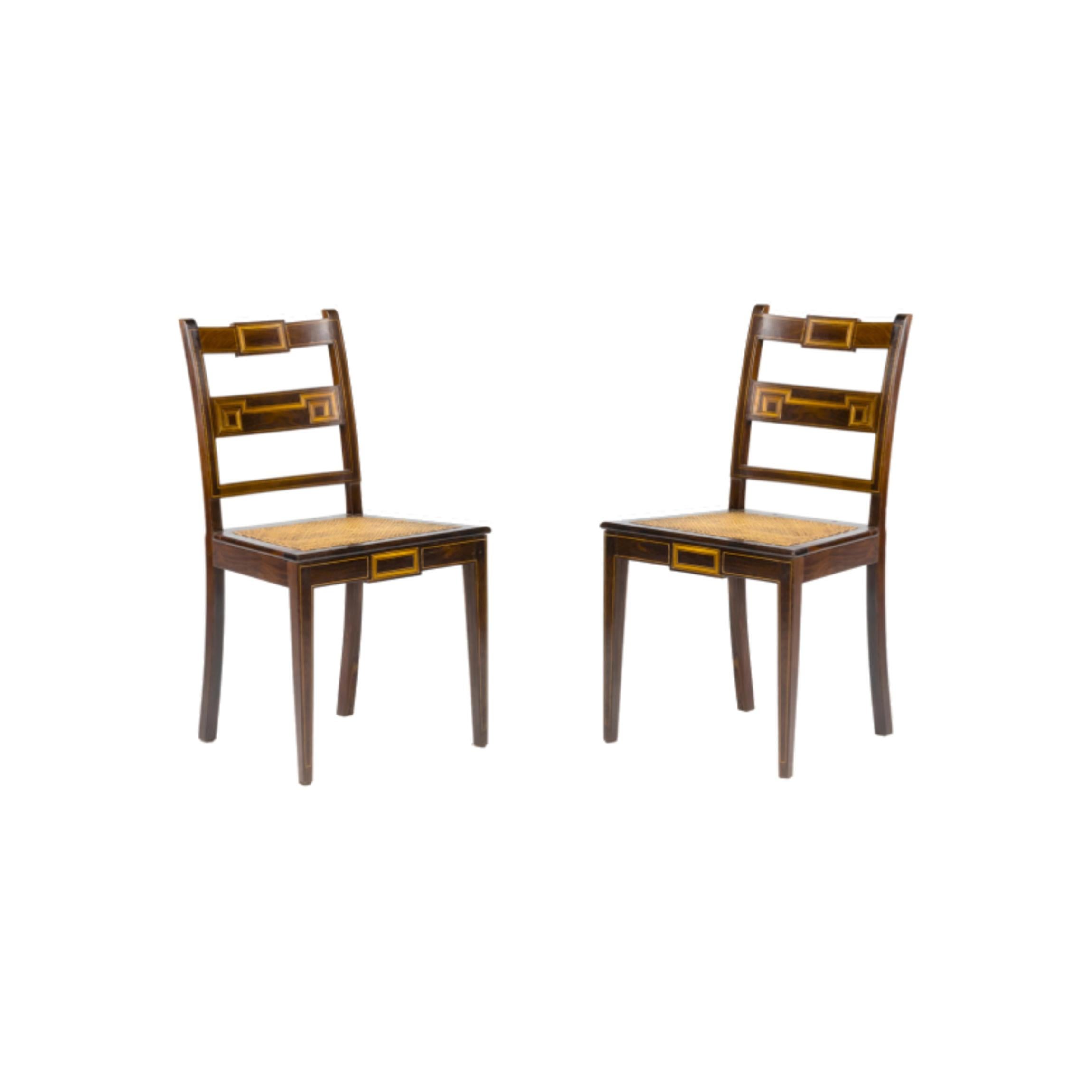 A carefully maintained pair of solid dining chairs with natural straw upholstery, inlaid linear marquetry and hand crafted . Revised by a carpenter and in excellent conditions. It has simple, straight lines