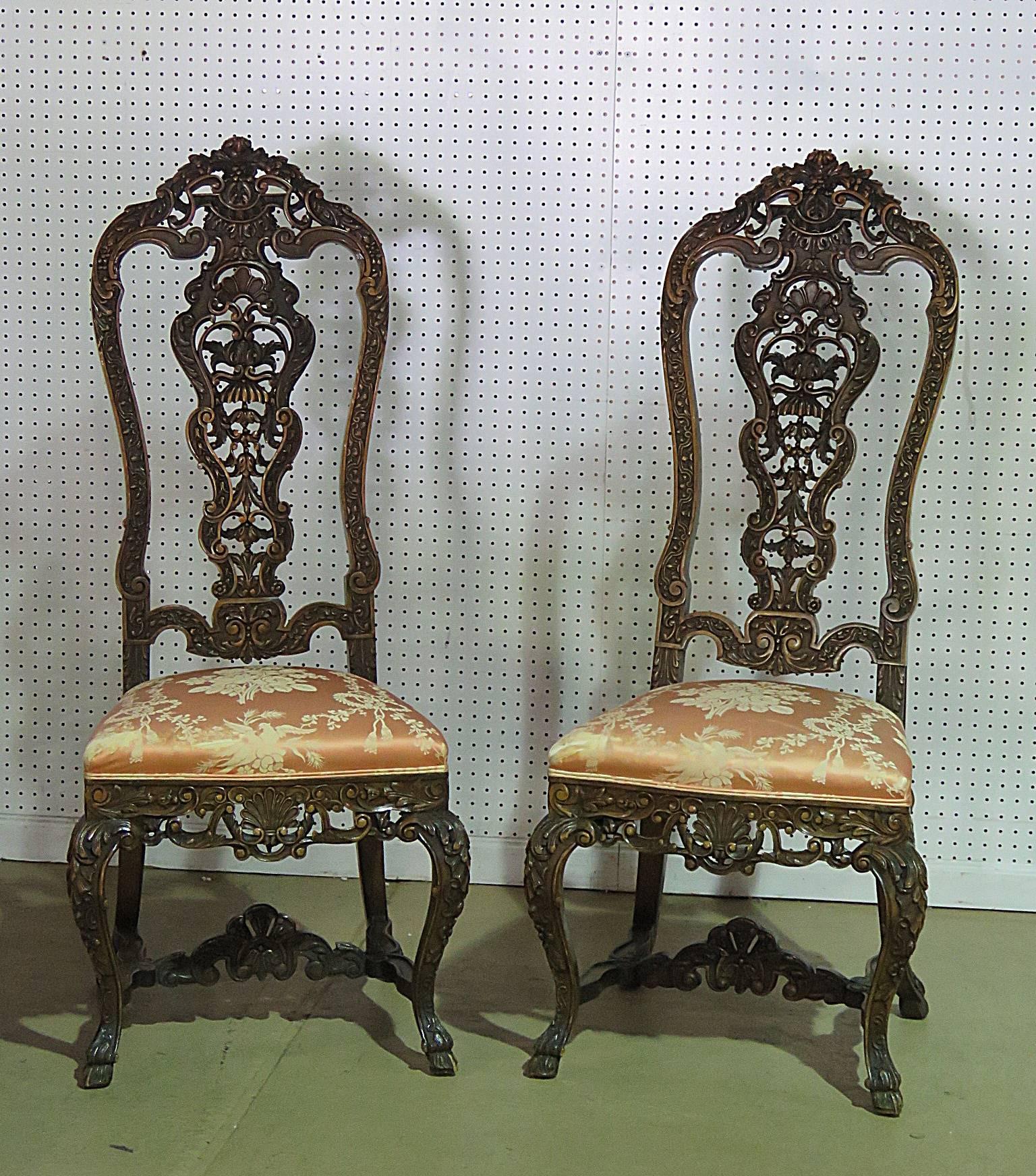 Pair of Baroque carved walnut side chairs with upholstered seats. The seat height is 21.25