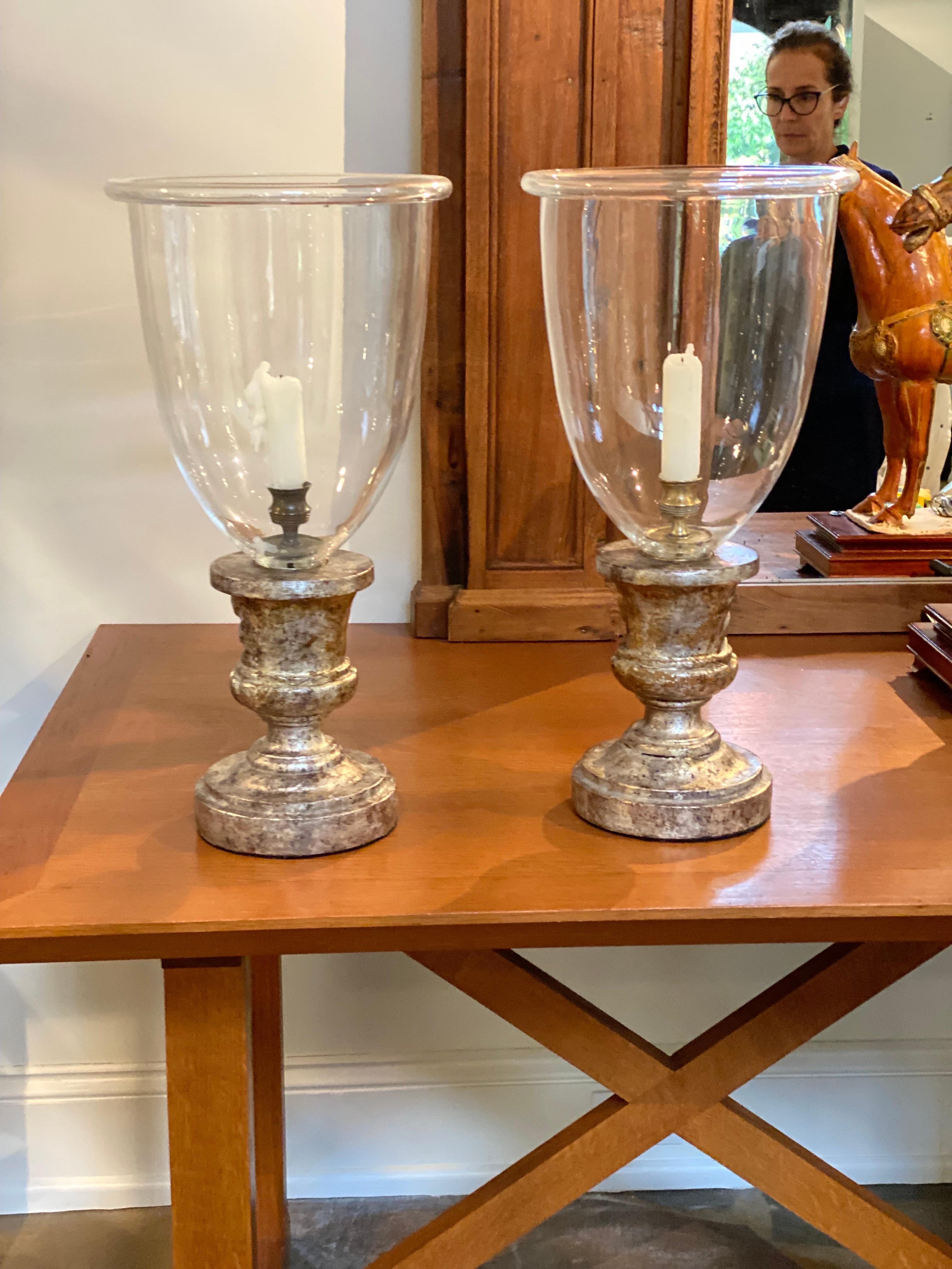 Pair of Baroque Silvergilt Fragments made into Candlesticks with Italian Blown Glass from John Rosselli.  Wooden Silvergilt fragments fabricated into table candleholders with Italian blown glass hurricane globes.  Good overall condition. Silvergilt