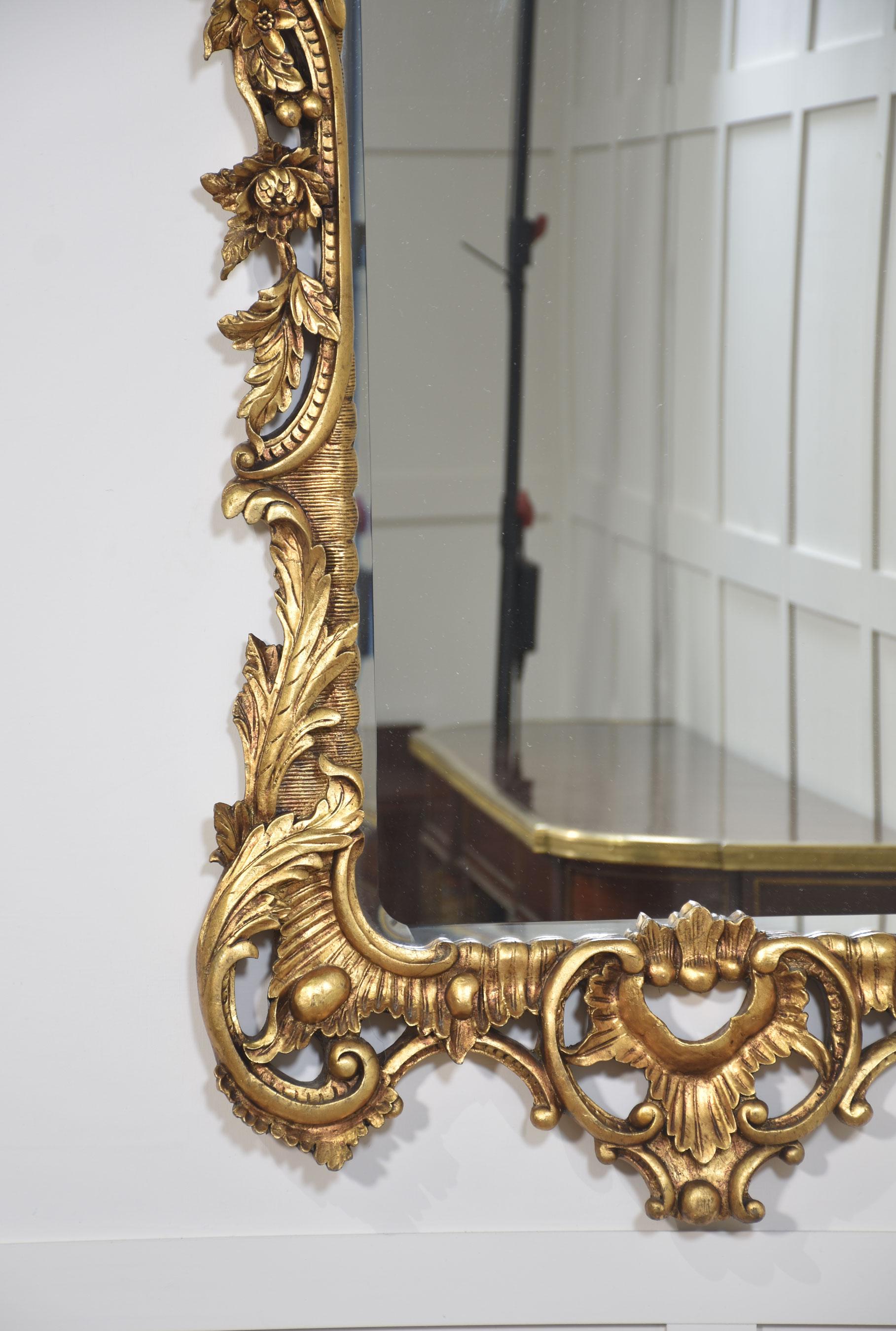 Pair of baroque-style carved and gilded mirrors. The original rectangular mirror plate is surrounded by a carved and pierced frame with rocaille work and scrolls, surmounted by scrolling acanthus leaves.
Dimensions
Height 60.5 Inches
Width 31
