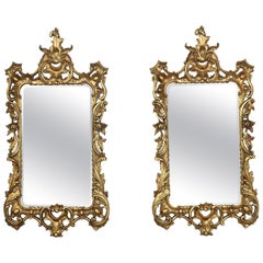 Pair of baroque style carved and gilded mirrors