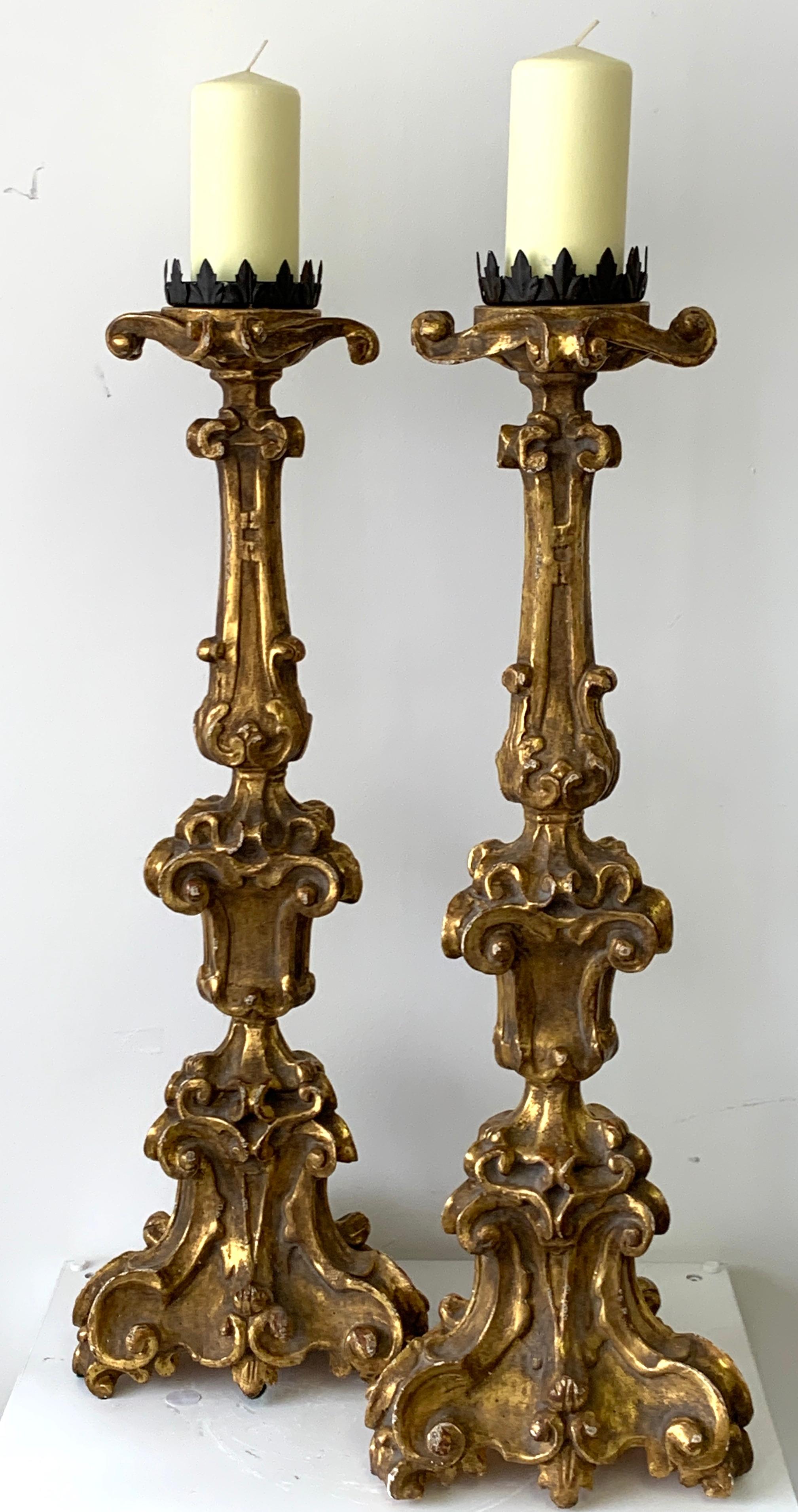 Pair of Baroque style carved giltwood pricket candlesticks, each one fitted with a 4