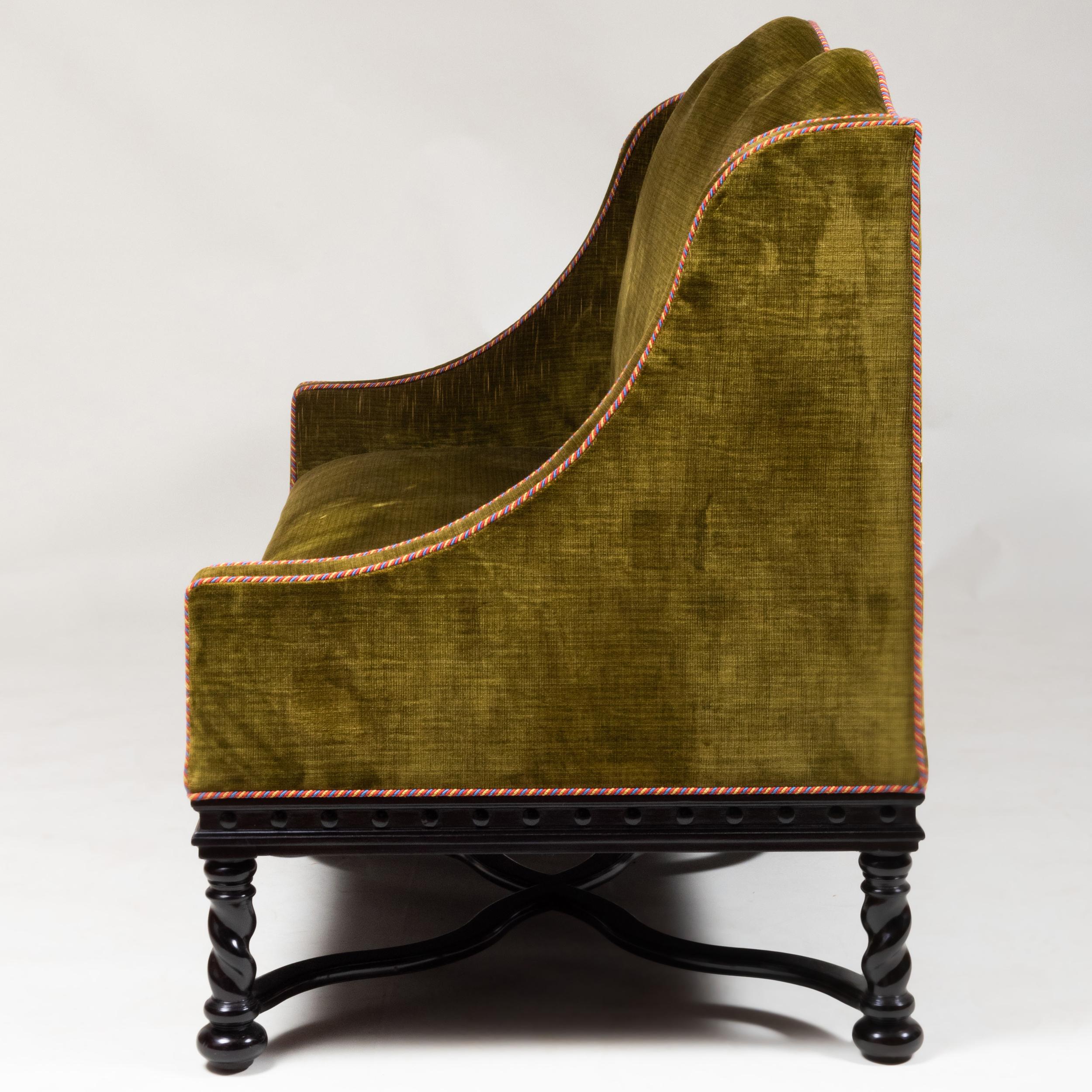 English Pair of Baroque Style Ebonized and Upholstered Sofas