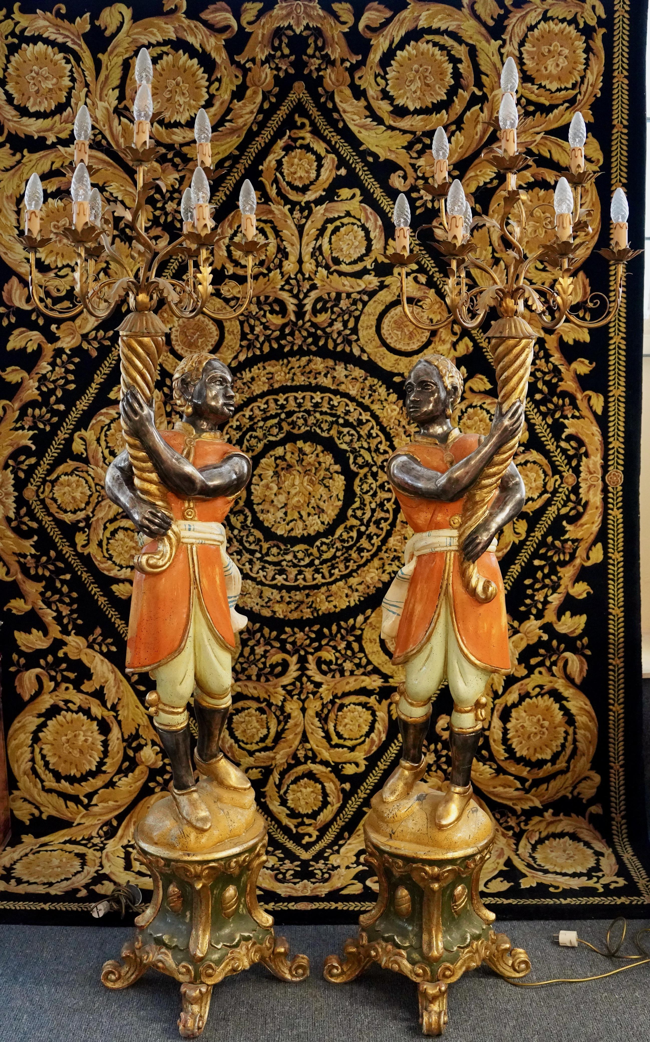 Coppia di lampade da terra in stile barocco, figure di candelieri veneziani, H. 203 cm, XX secolo.

Questa splendida coppia di lampade da terra del XX secolo è un superbo esempio dell'artigianato e del design ornato dello stile barocco. Le lampade