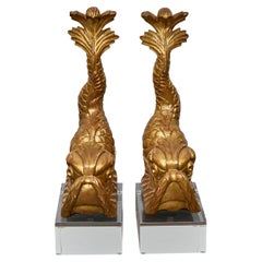 Pair of Baroque Style Giltwood Dolphin Carvings on Lucite Bases, 19th century