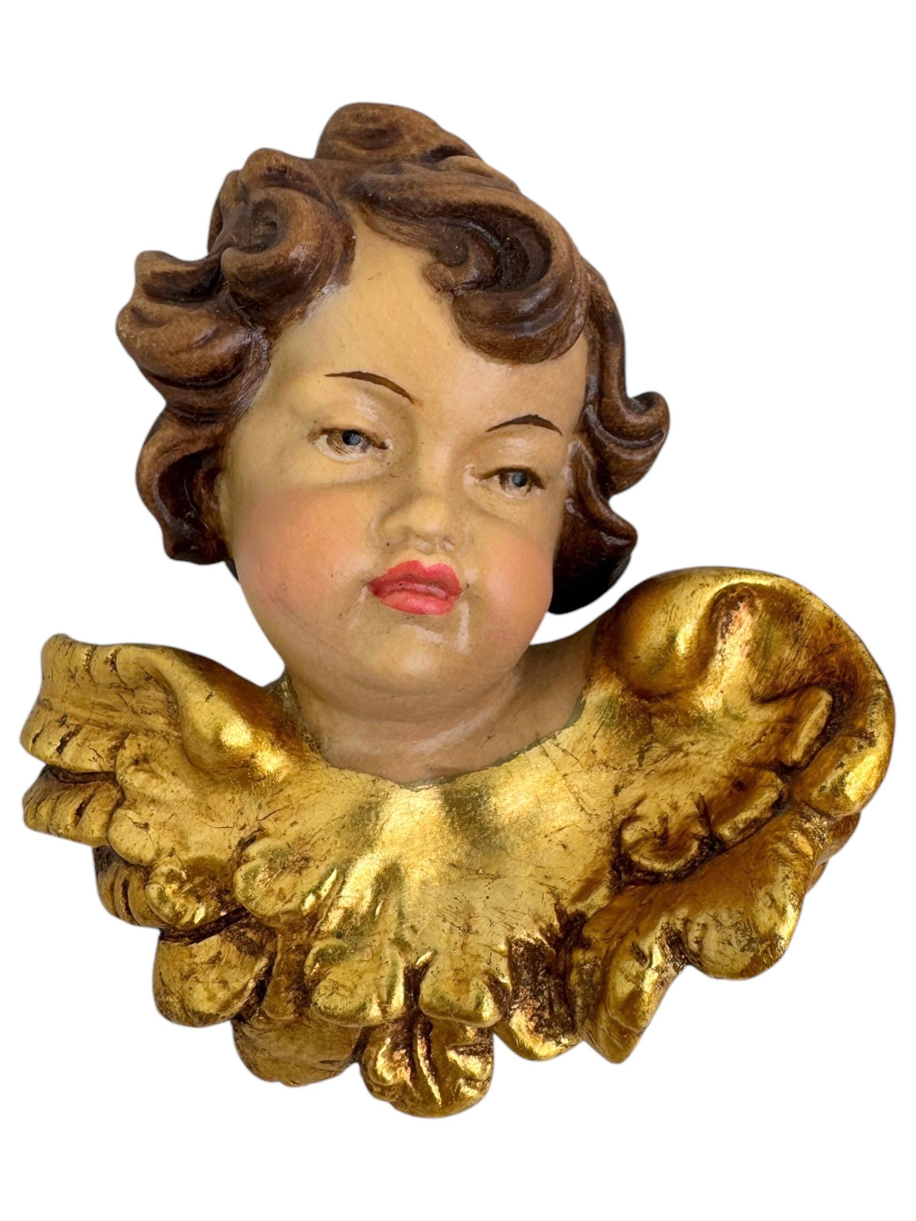 A pair beautiful hand carved and hand painted cherub angel Heads, found at an estate sale in Germany. Made by a woodcarver in the South Tyrollean area, this area is well-known for their wood carvings. Attributed because of the quality to Anri,