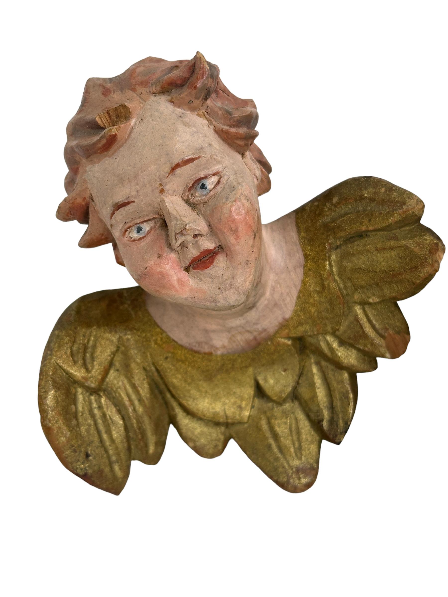 A pair beautiful hand carved and hand painted cherub angel Heads, found at an estate sale in Nuremberg, Germany. Made by a woodcarver in the Oberammergau area, this area is well-known for their wood carvings. The size given in the dimensions section