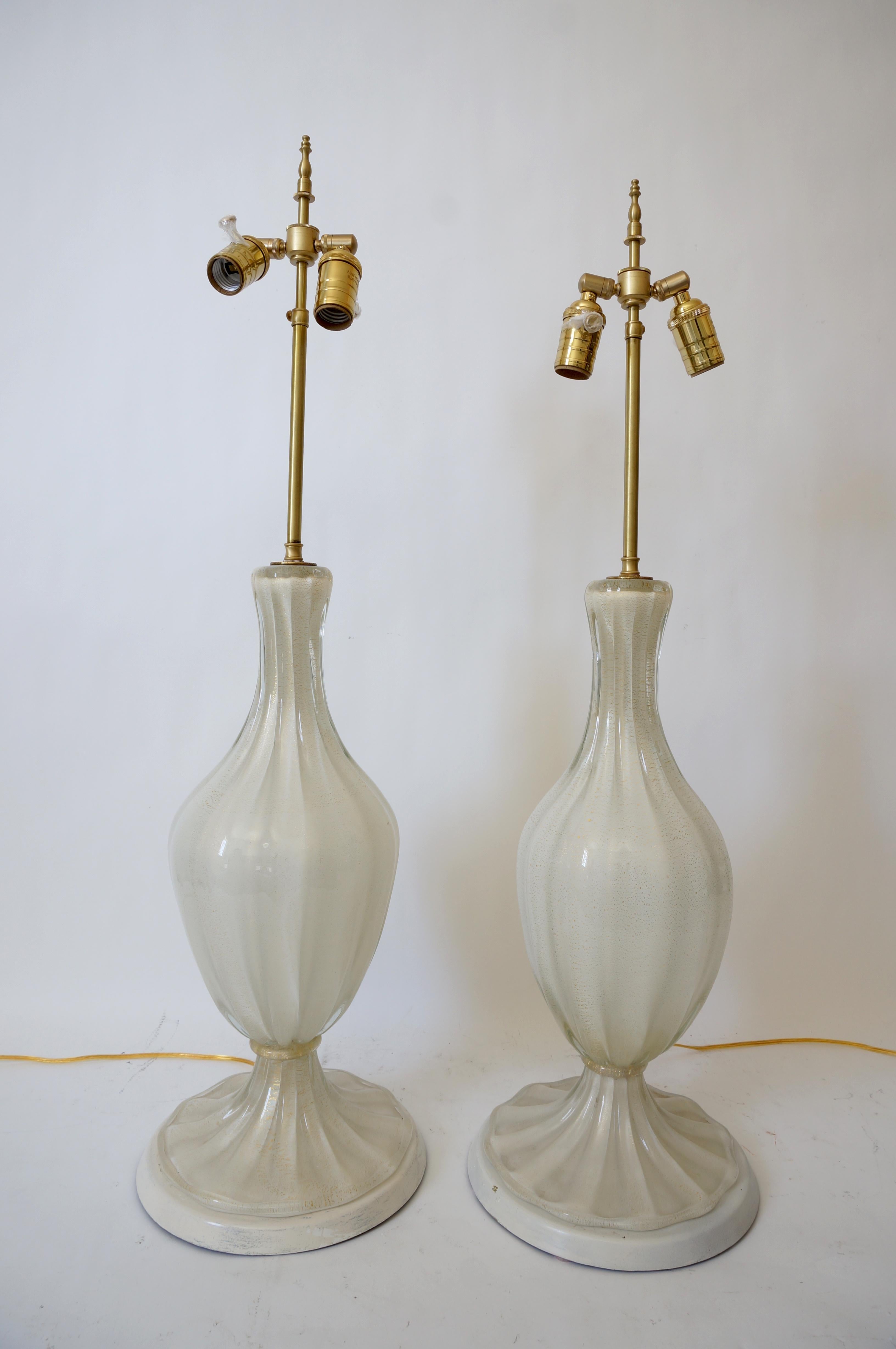 This large scale, stylish and chic pair of Murano glass lamps date to the 1950s-1960s and were created by the iconic workroom of Barovier et Toso. 

Note: Dimension of the Murano sections are 21