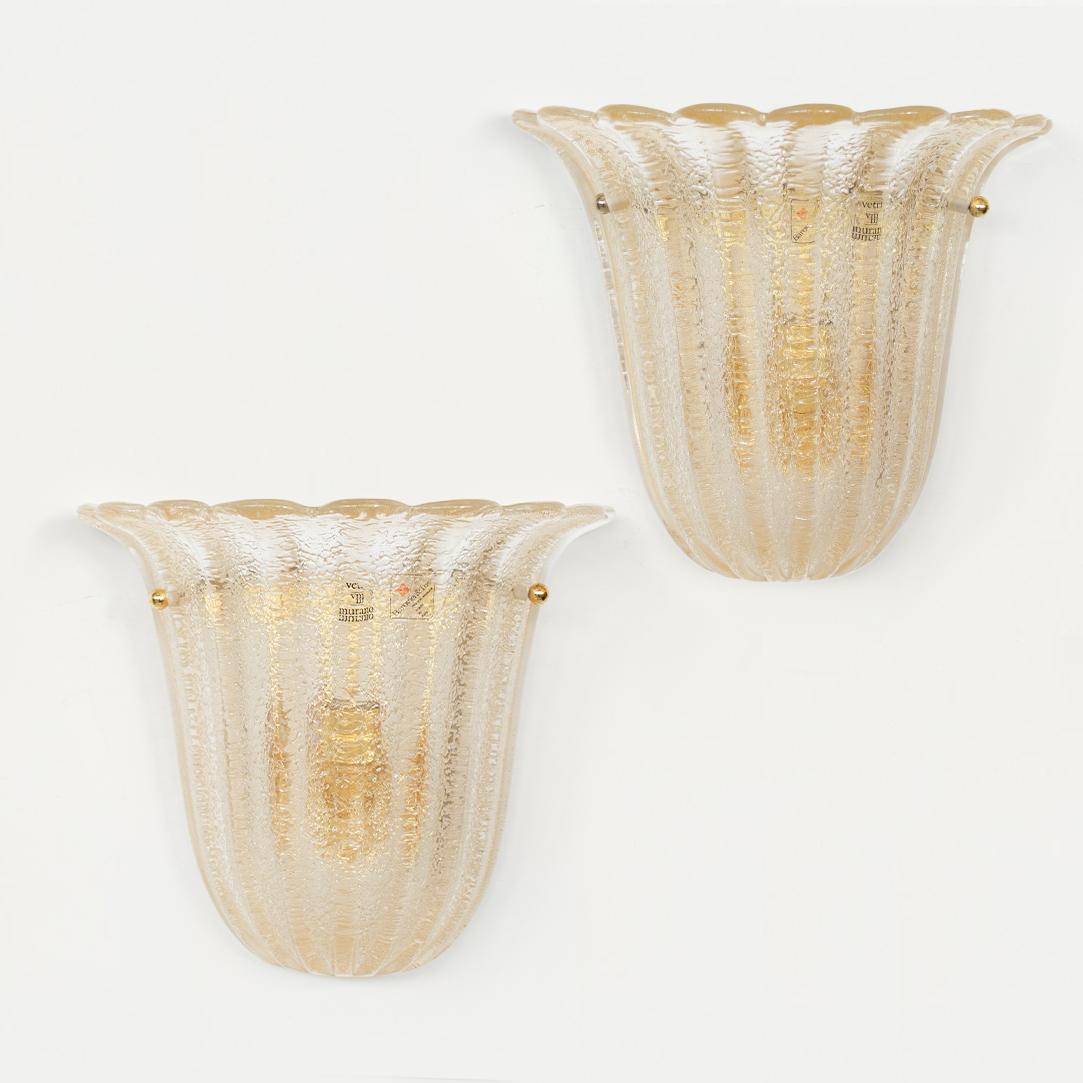 Beautiful pair of warm hued glass sconces with gold specs and scalloped top edge by Barovier & Toso, Italy, 1980's. Newly rewired. 4 pairs available, priced as a pair. Original Barovier & Toso maker stickers on glass, can be removed.