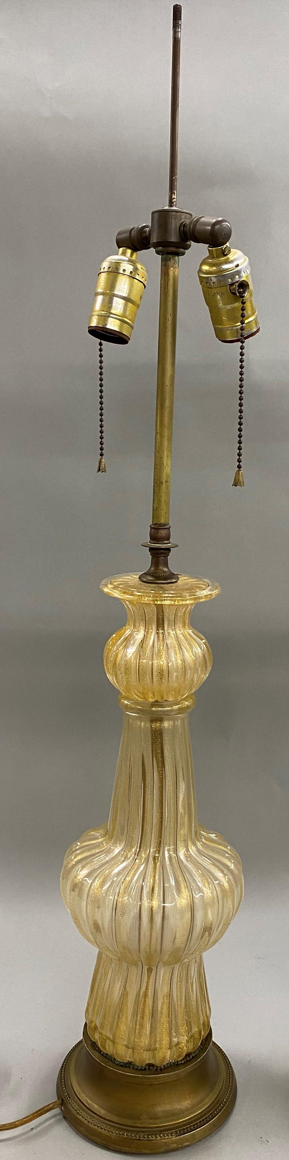 An elegant pair of Barovier Venetian glass two-light table lamps with Fine form and 22-karat gold dust inclusions on gilt bases,original wiring, in good working condition, with minor surface imperfections and wear commensurate with age and use. The