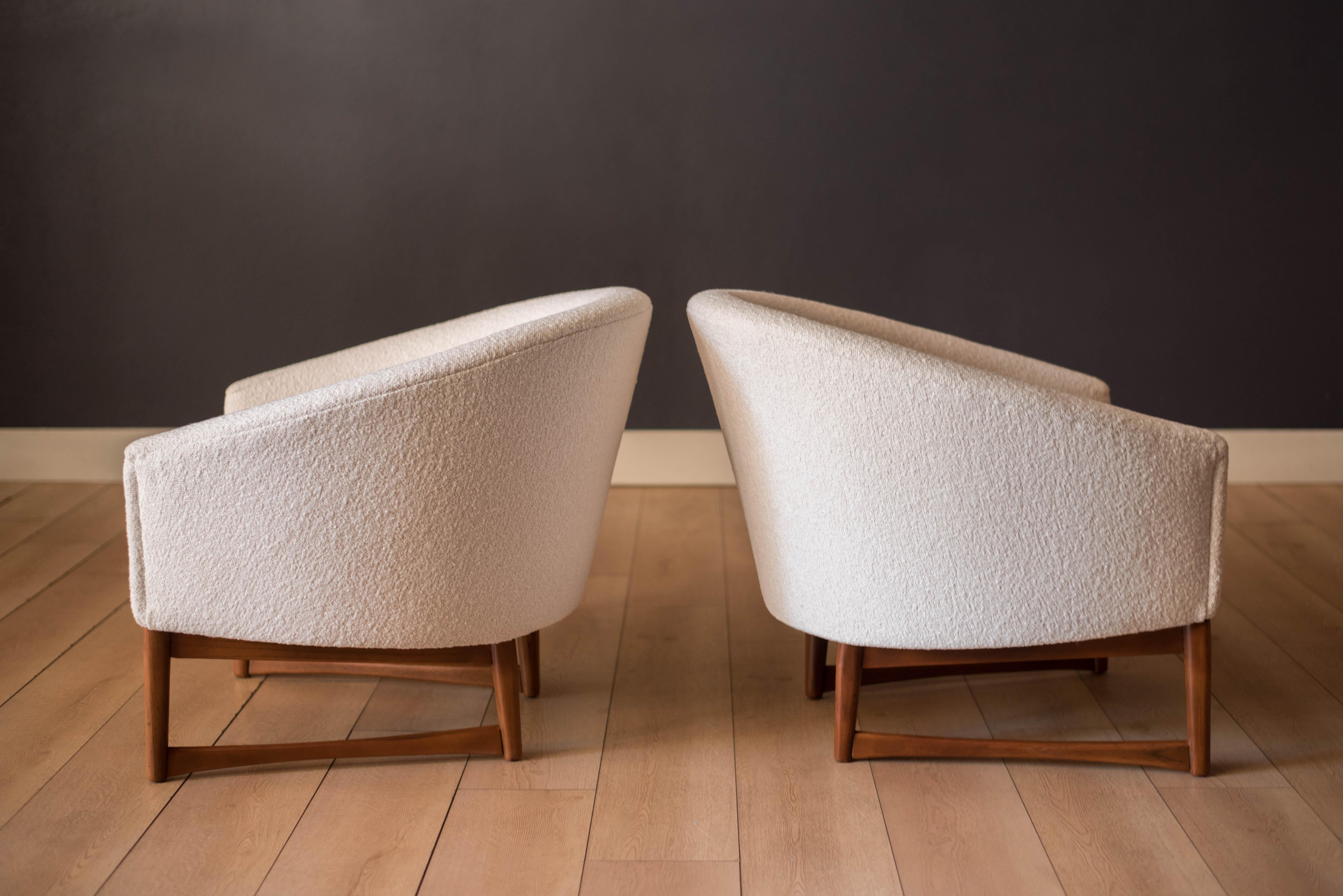 Mid century modern pair of round barrel tub chairs designed by Lawrence Peabody for Richardson Nemschoff, circa 1950's. This set has been newly reupholstered in a soft white boucle textile fabric. Features a contrasting angular solid wood base