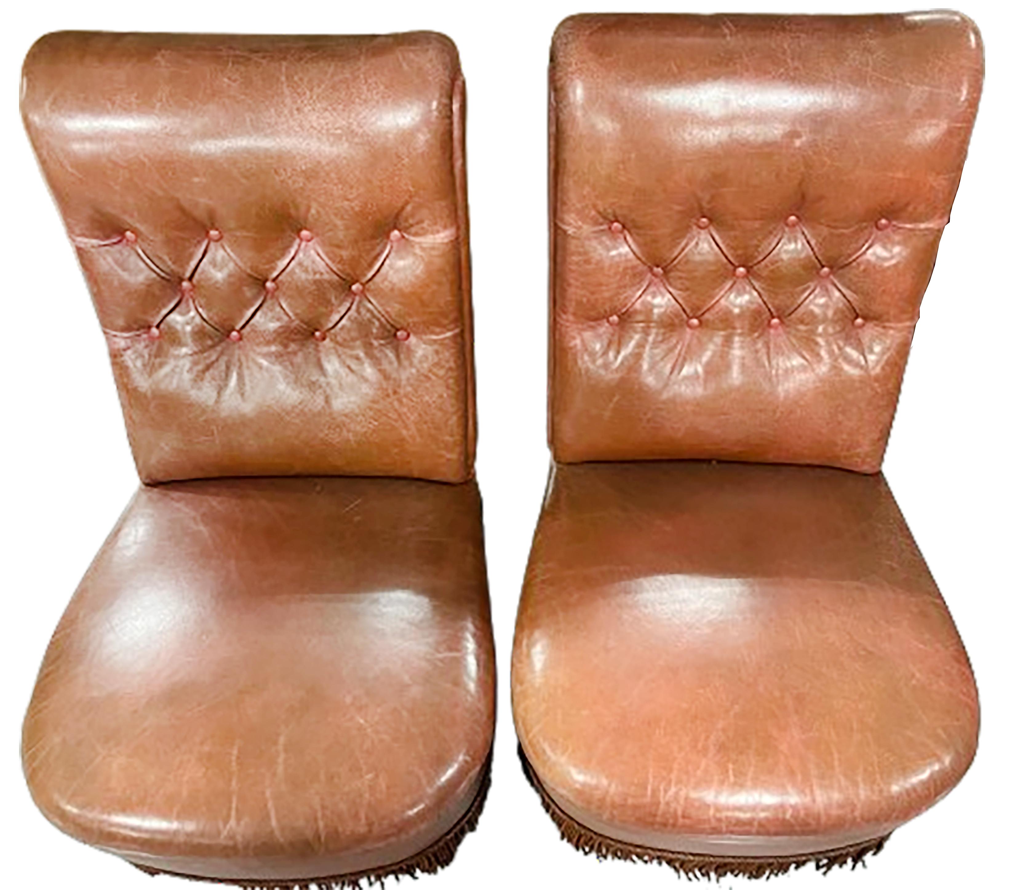 A handsome pair of tufted leather upholstered with tasseled apron side chairs. Rich red sienna patina.

No obvious markings on the bottom of the base or piece. 

In good condition. Gentle wear consistent with age and use.

This set would make a