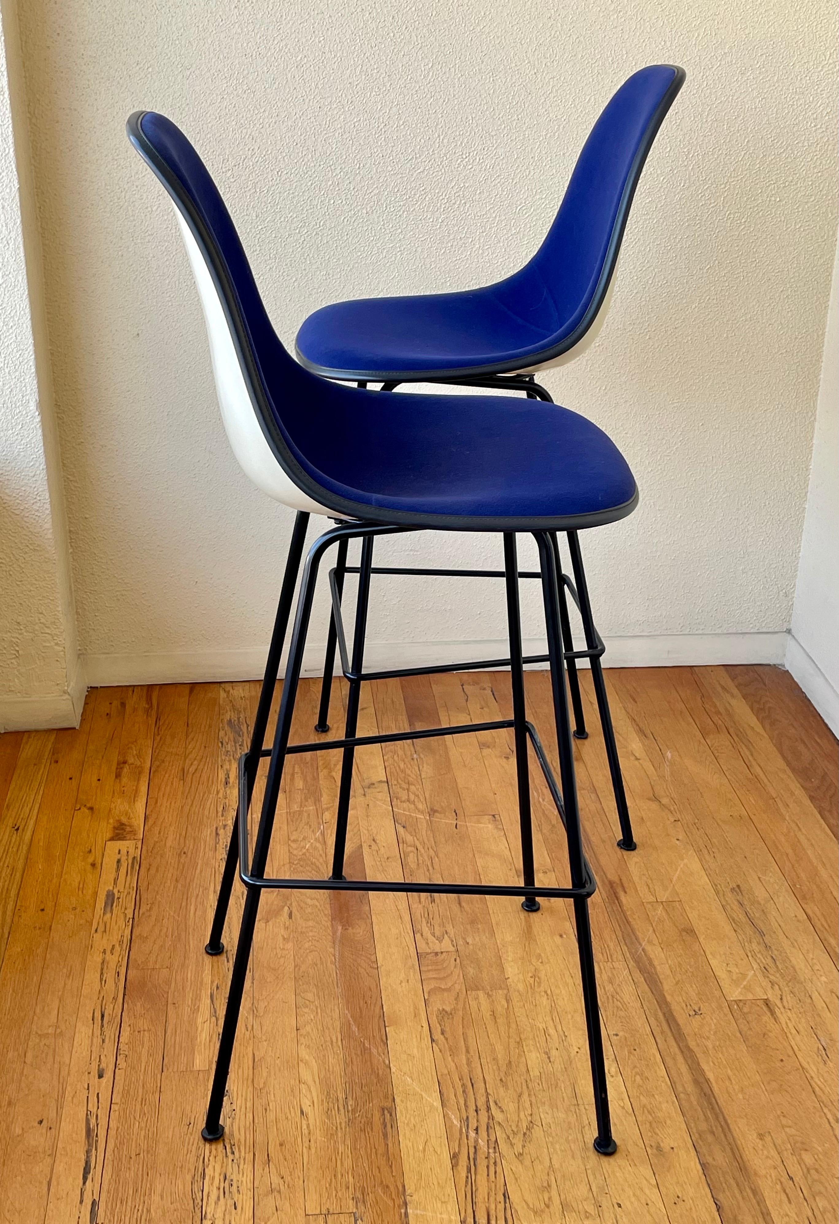 Nice pair of rare barstools designed by Charles Eames for Herman Miller circa 1970s, the navy blue velvet seat cover shows light wear and light stains as shown on the pics but has nice foam overall. The fiberglass shells are in good condition. with