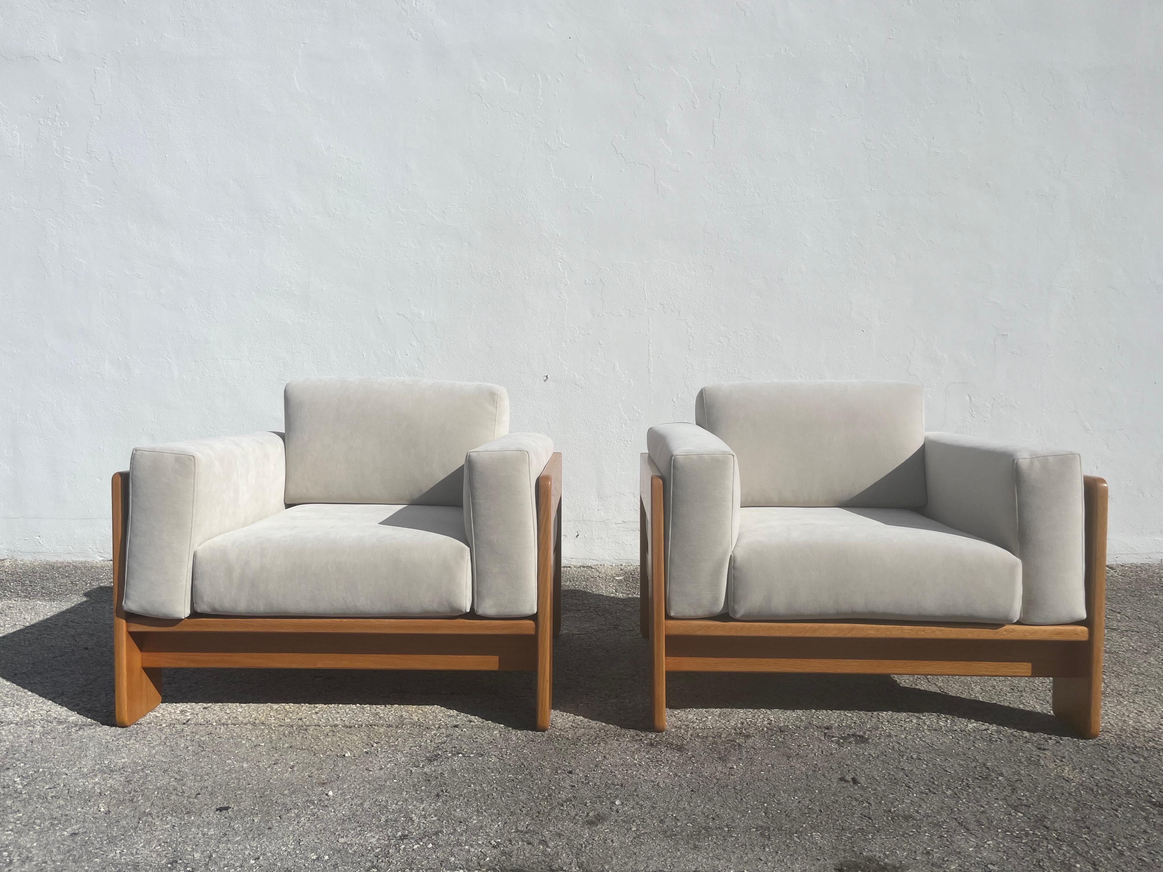 Pair of Bastiano Chairs by Tobia Scarpa from 1979. Oak and Fabric. Chairs were recently recovered in Architex Ultraposh 20801 Ivory. The Oak veneered frames were also refinished and unfortunately the Refinisher removed the original label. Seat depth