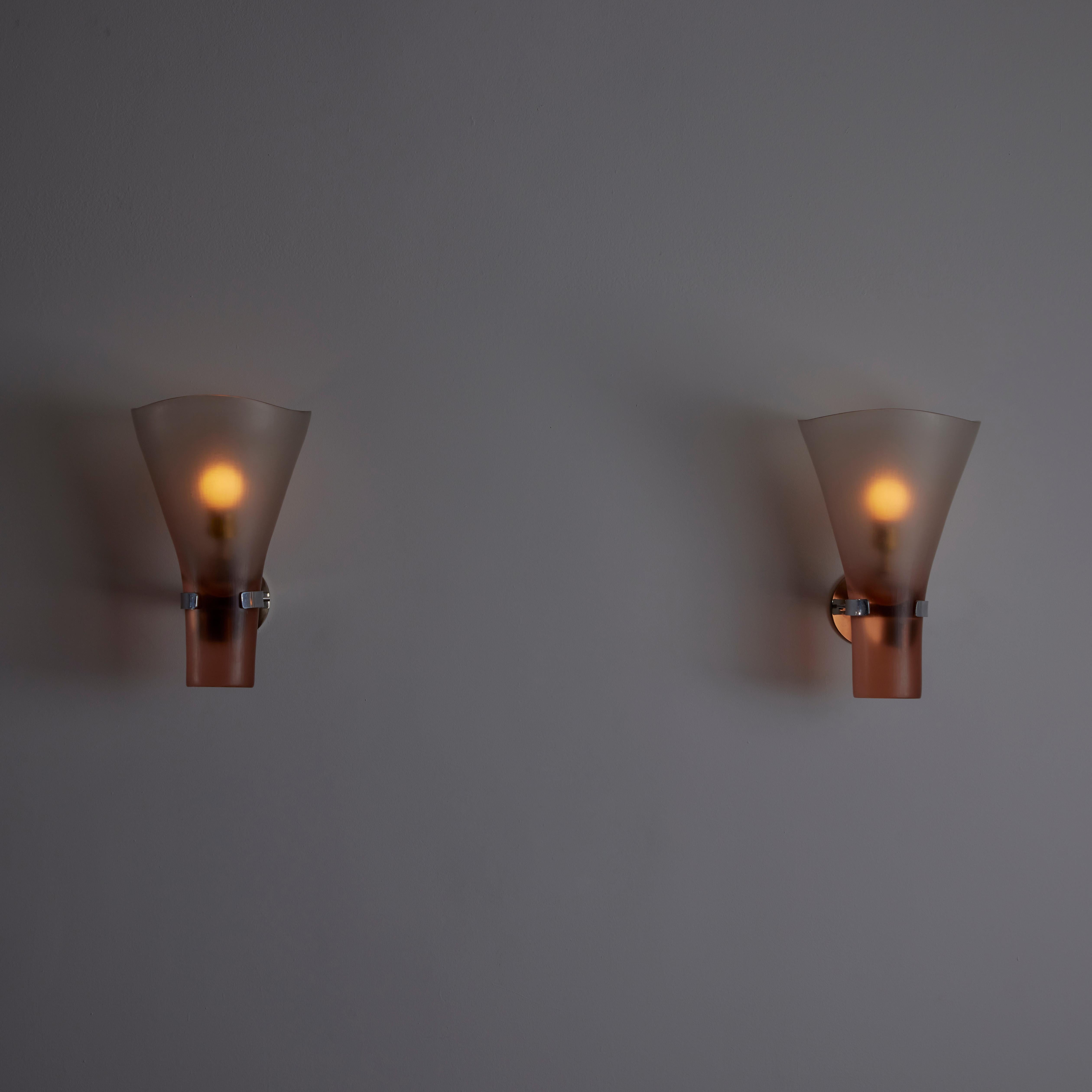 Rare Pair of Battuto Murano Sconces by Tobia Scarpa for Venini, in Italy in 1967. Chalice-shaped wall sconce in a soft pink translucent finish. We recommend a 40w maximum E12 bulb. Wired for US Standards. Bulbs are not included.

Literature: Franco