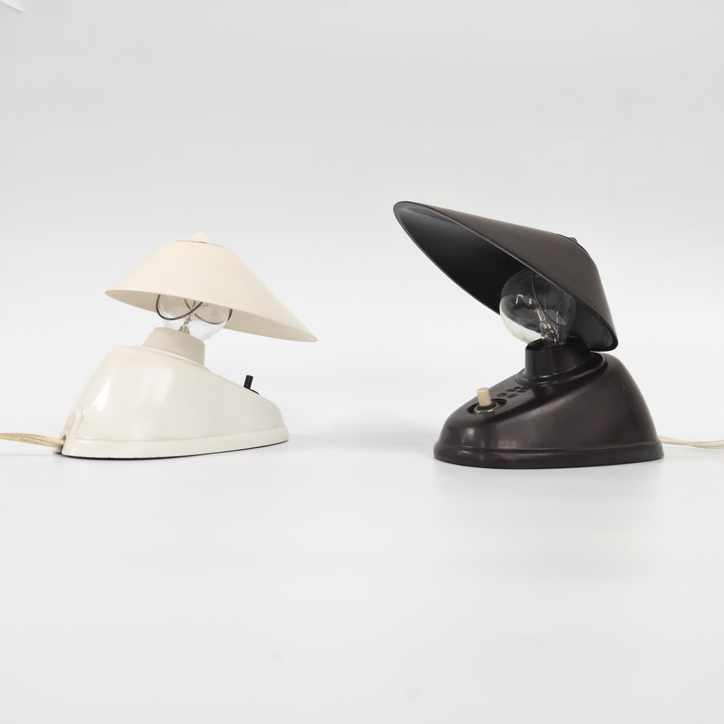 Manufactured by Elektrosvit Nové Zámky under catalogue number 11641. Former Czechoslovakia 1950s. Crafted from black and white bakelite, can be hung as a wall light or used as a desk lamp. Despite its strong pre-war modernist aesthetic, it's often