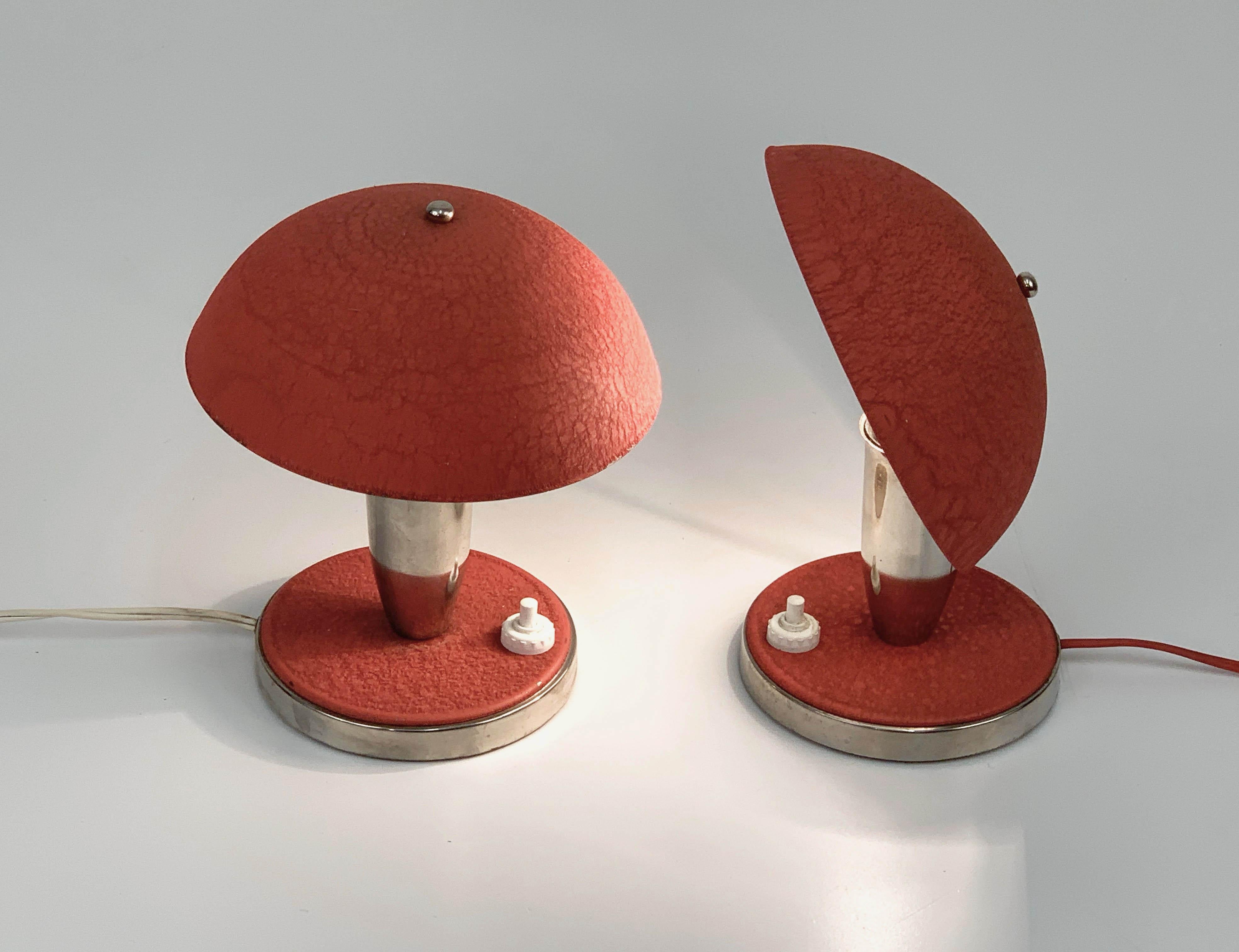 Wonderful pair of Bauhaus red table lamps produced during the 1930s in Czech Republic.

They are both functional and decorative, with their adjustable metal shade and with their original wiring system. They mount a large E27 fitting lamp.

One