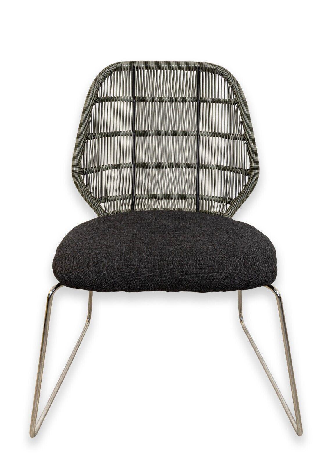 A pair of B&B Italia crinoline and stainless steel chairs. A gorgeous set of accent chairs featuring a classic design but a unique set of materials. These chairs feature a stainless steel frame with a dark grey fabric cushion, and a strung crinoline