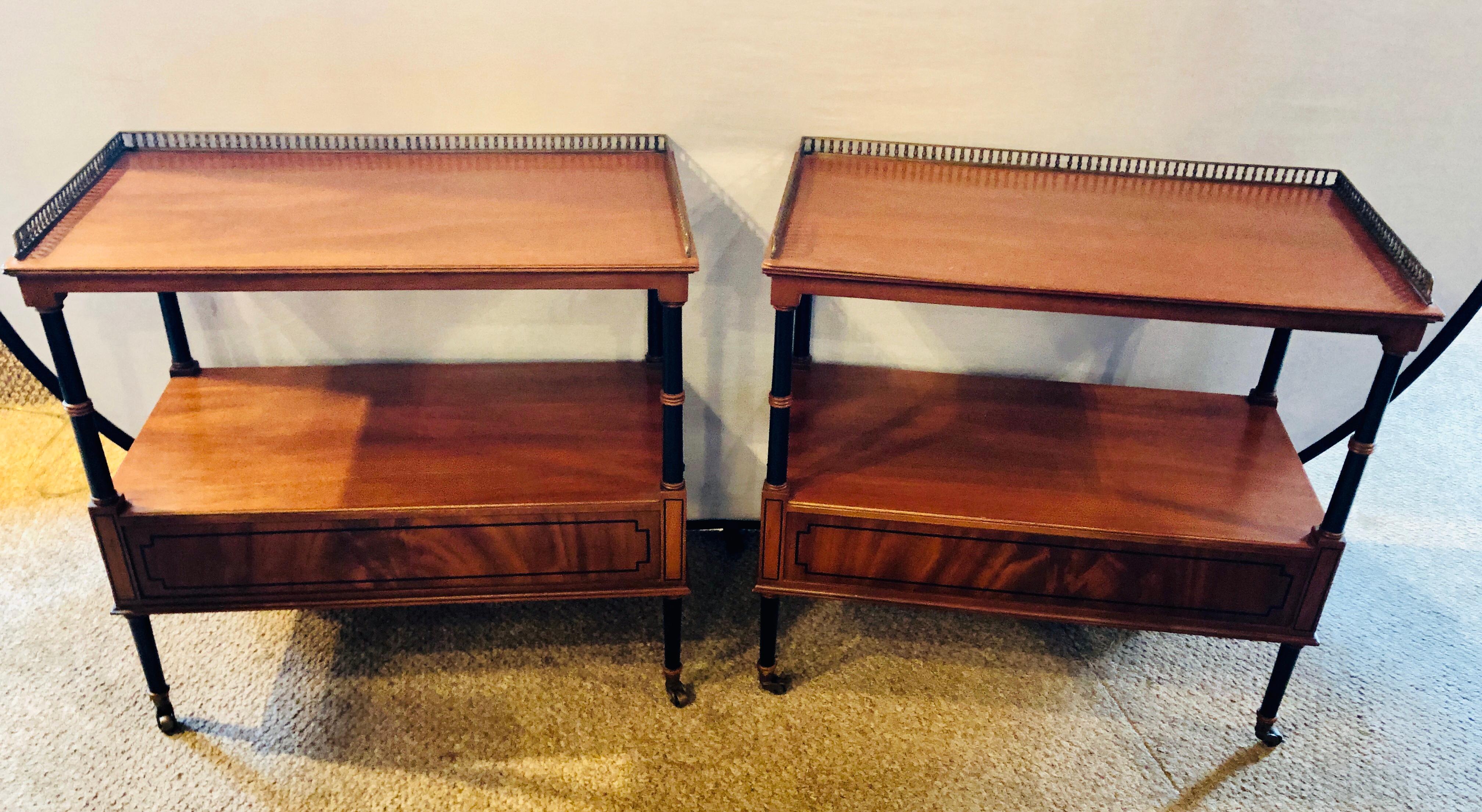 Pair of Beacon Hill mahogany and ebony galleried stands with side drawers.