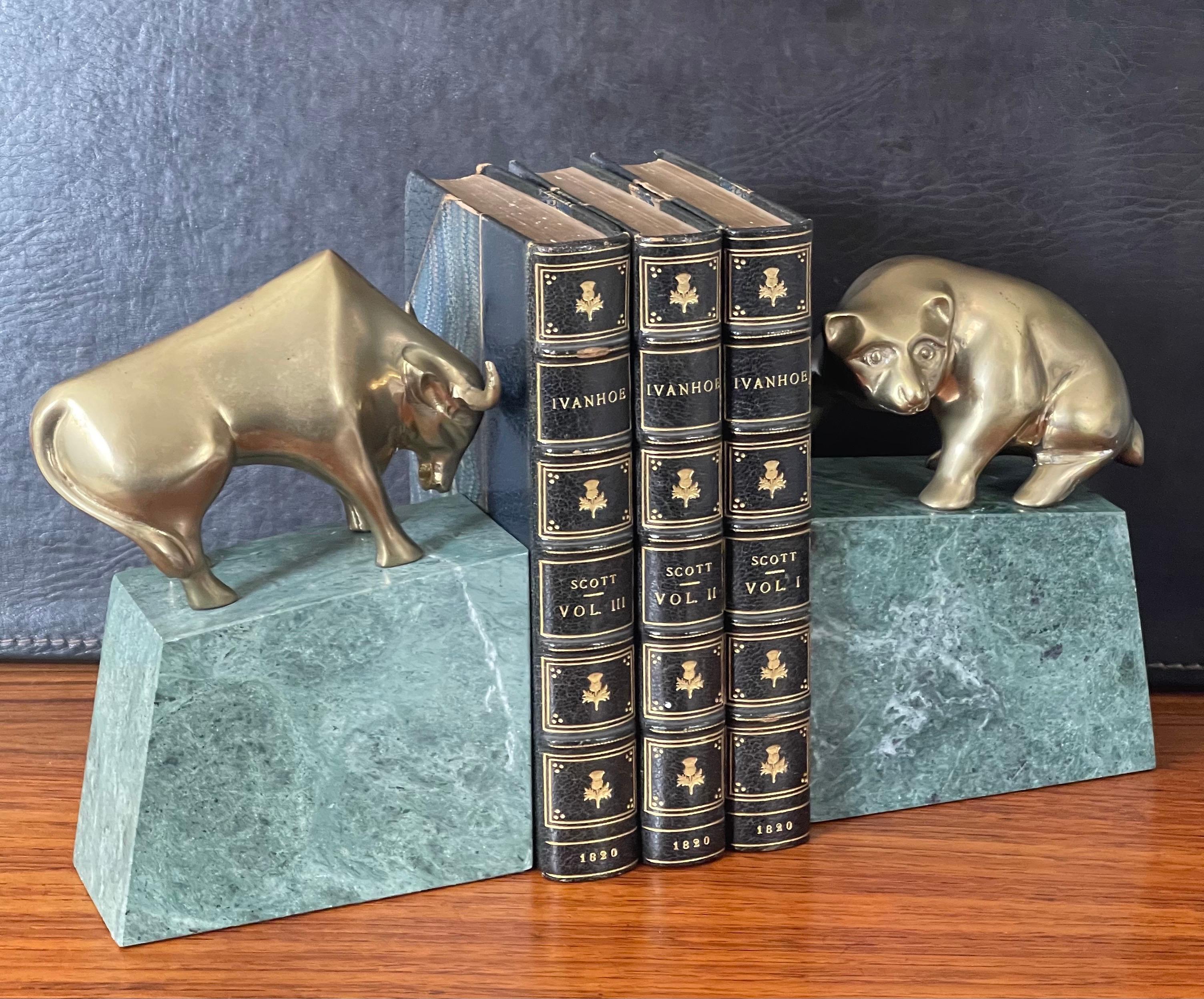 Fun pair of bull and bear bronze and green marble bookends, circa 1990s. The pair measure 10