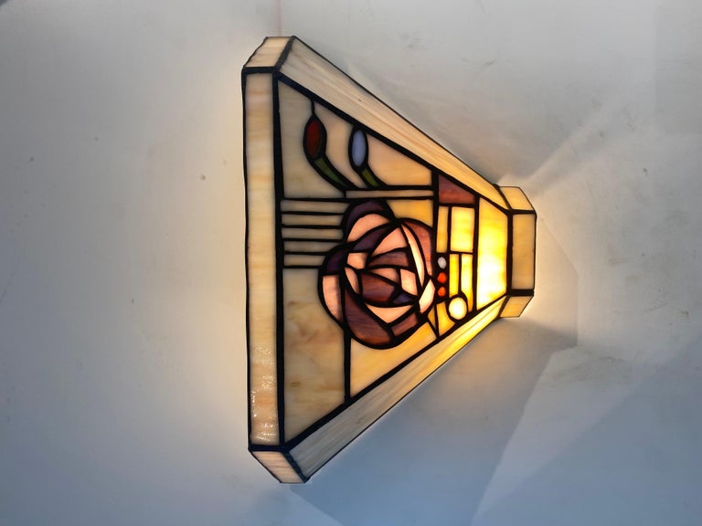 A stunning pair of French Art Deco style Altuglas wall sconces with beautiful hand crafted colored flower.
The glass shade adds extra interest and allow some diffused light through the stained glass.
Can be delivered and wired for American or