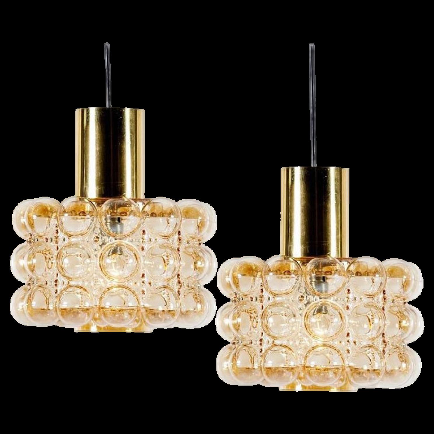 Pair of beautiful bubble glass chandeliers or pendant lights designed by Helena Tynell for Glashütte Limburg. A design Classic, the hand blown amber glass gives a wonderful warm glow.

The dimensions: Height 80 cm from ceiling, the diameter 30 cm.