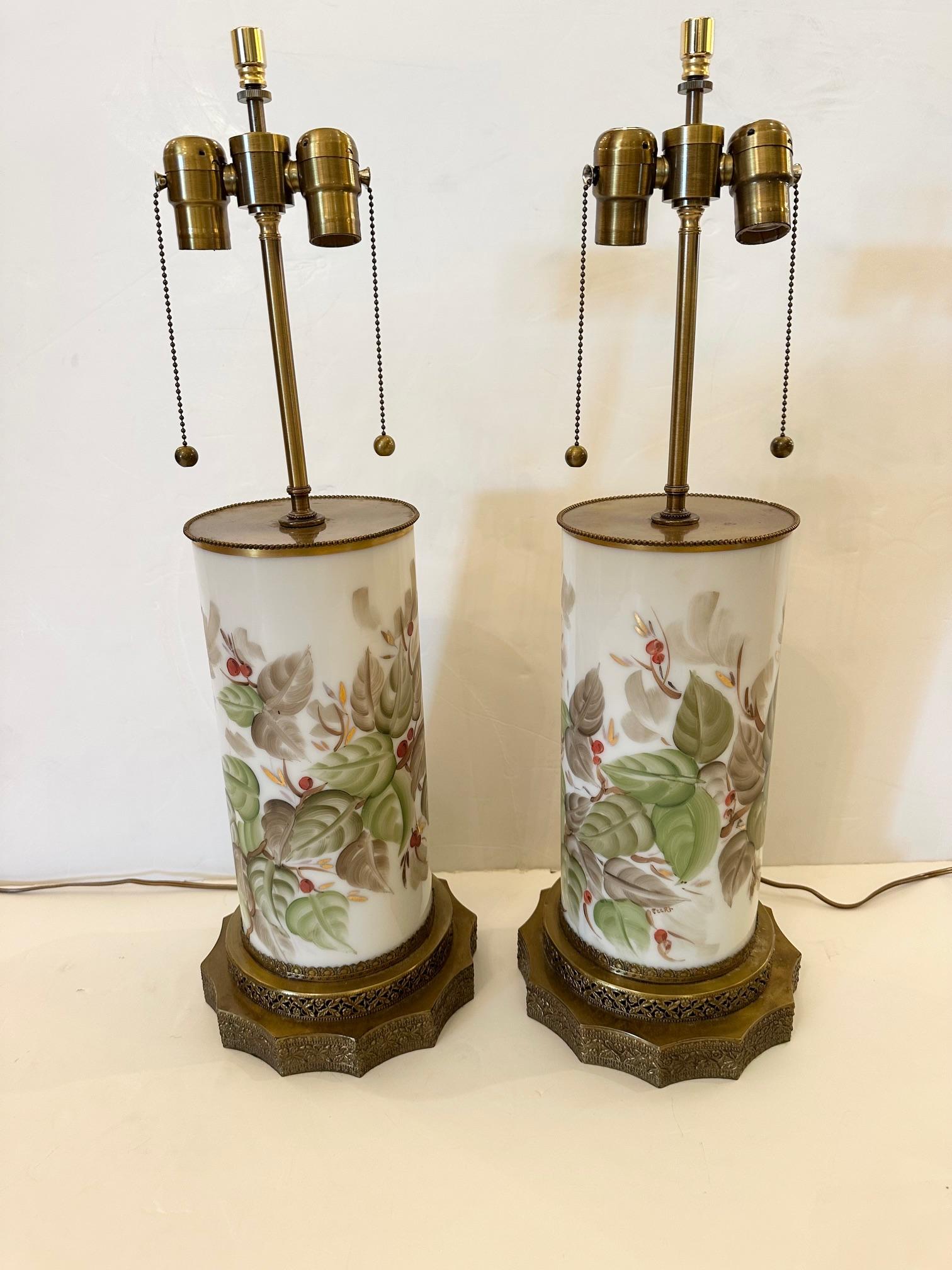 Pair of elegant Chinese hand painted porcelain table lamps having new leaf shaped finials and chocolate colored custom shades.  Lovely brass filigree bases.

SW

30” H to finial. 9” diameter base of lamp
Shade 16” diameter bottom
