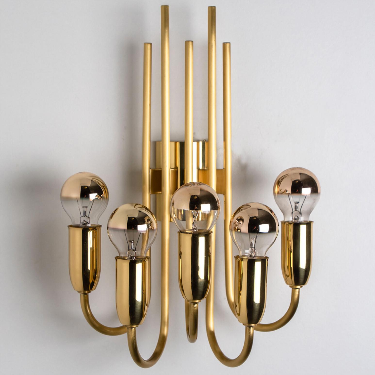 Pair of Beautiful gold and brass wall light in the style of  Florian Schulz, Germany, Europe. Design period: 1970-1979.

Five glass spheres pointed upwards, each supported by a curved brass rod. The spheres are supported at different heights,