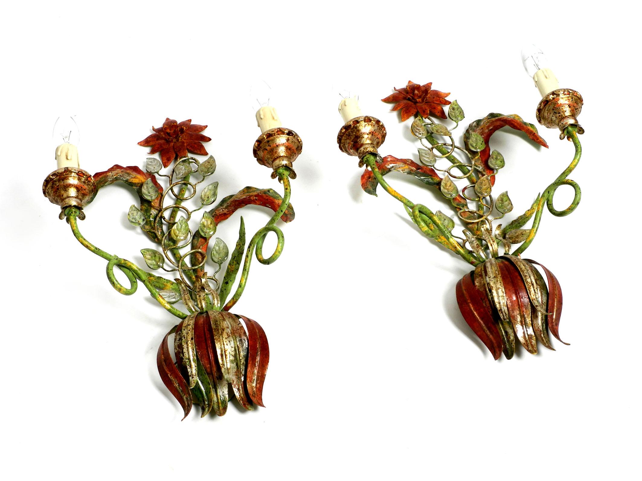 Pair of beautiful large floral Italian Mid-Century Modern metal wall sconces. Solid and high quality production. Elegant Italian design of the 1950s.
The frame with the leaves is made of green and brown-red lacquered metal.
Glass stones are