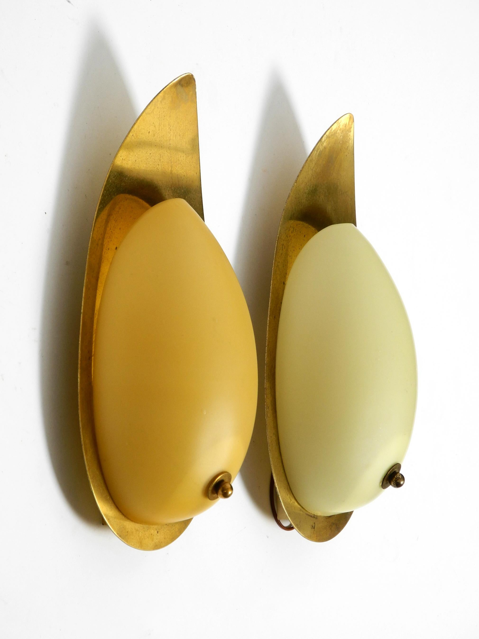 Mid-Century Modern Pair of beautiful Mid Century brass and beige glass sconces shaped like a drop For Sale