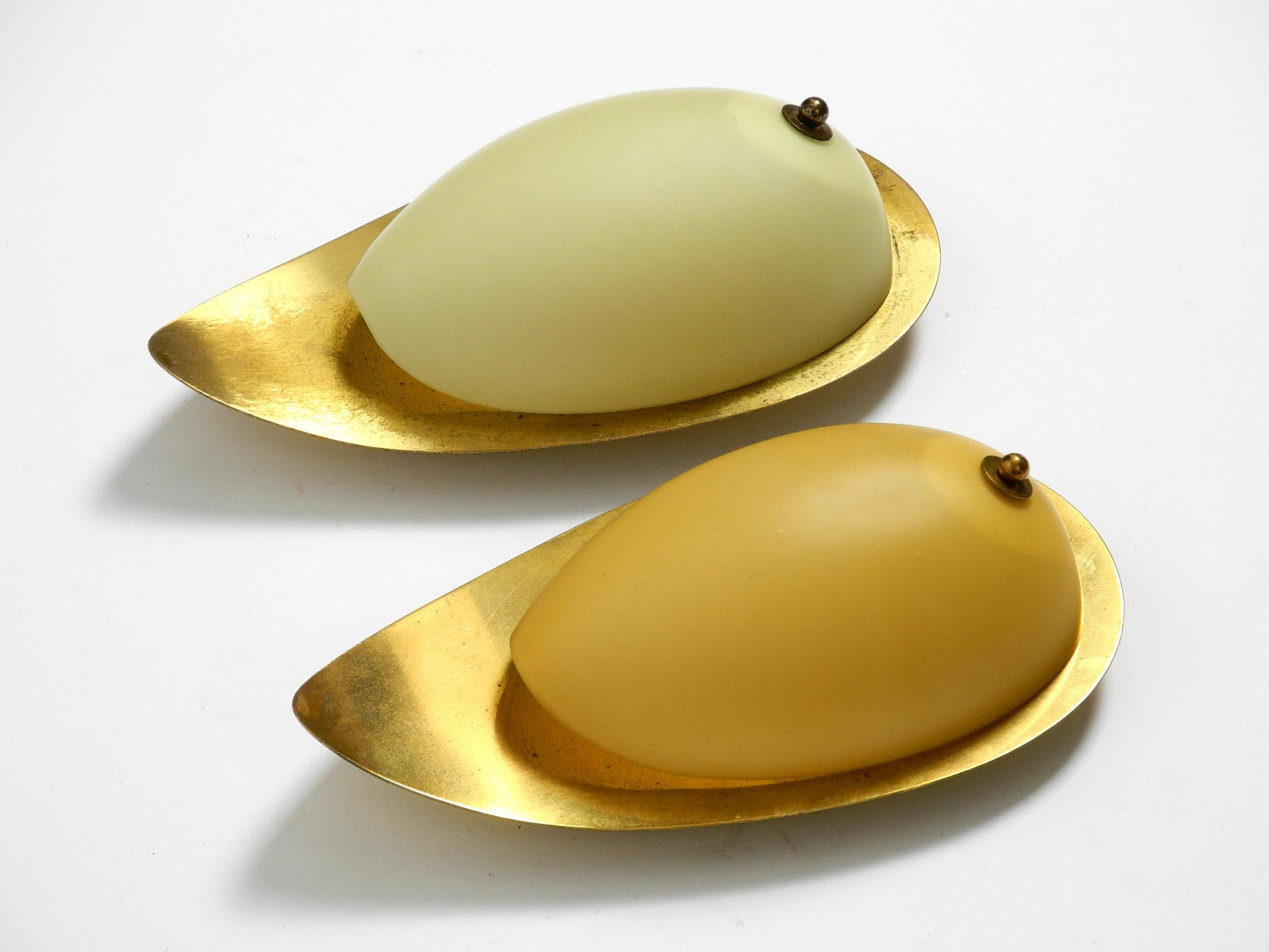 German Pair of beautiful Mid Century brass and beige glass sconces shaped like a drop For Sale