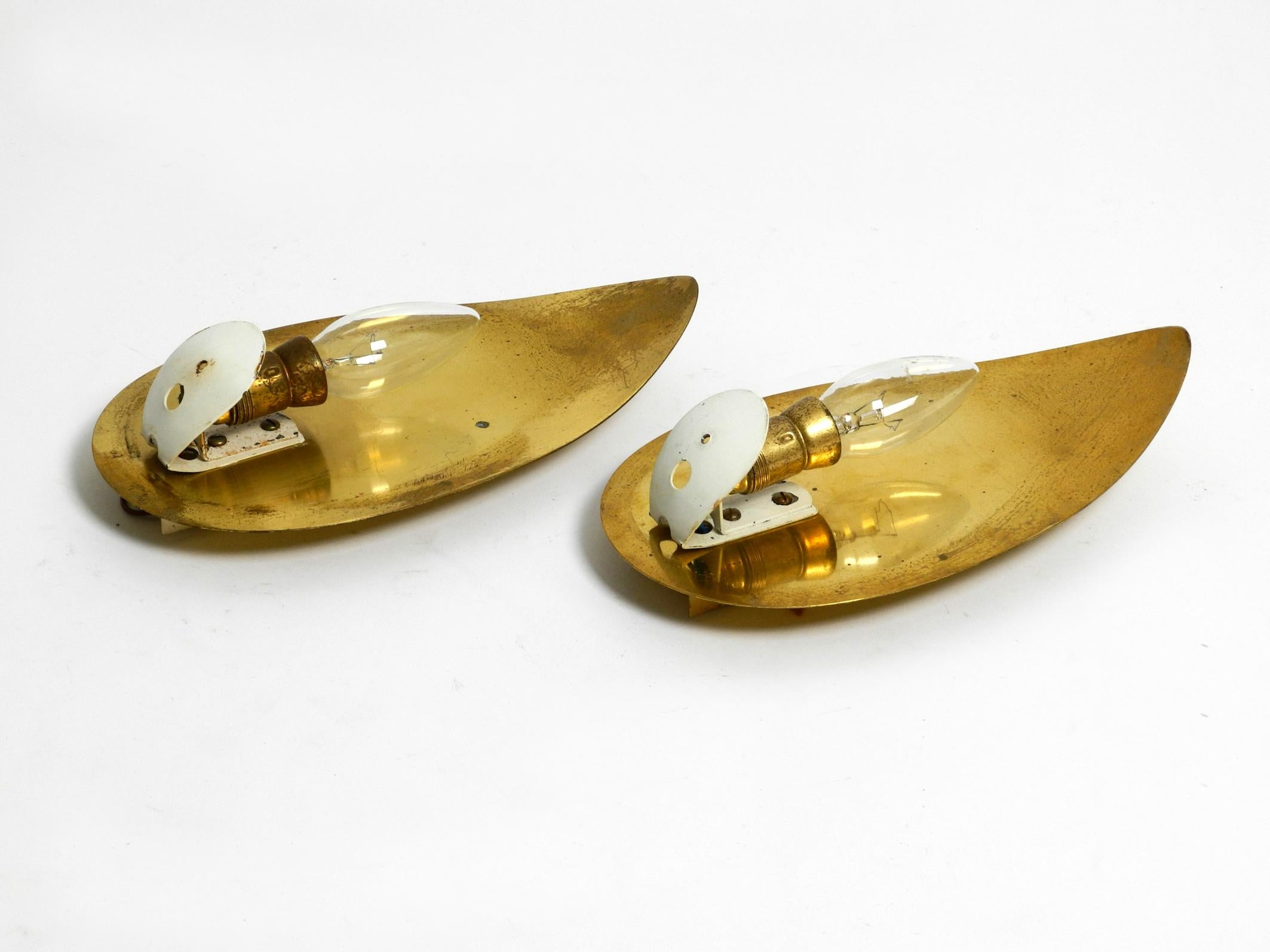 Brass Pair of beautiful Mid Century brass and beige glass sconces shaped like a drop For Sale