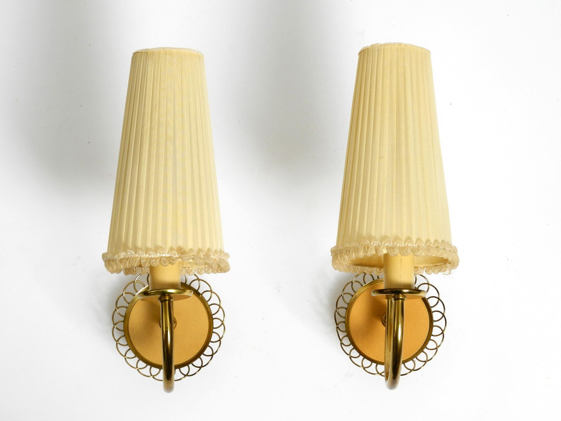 Pair of beautiful original mid century brass wall lamps from Vereinigte Werkstätten.
Made in Germany. With the original silk lampshades
Great high quality 1950s design.
The arms can be moved continuously to the left and right. Holds in any