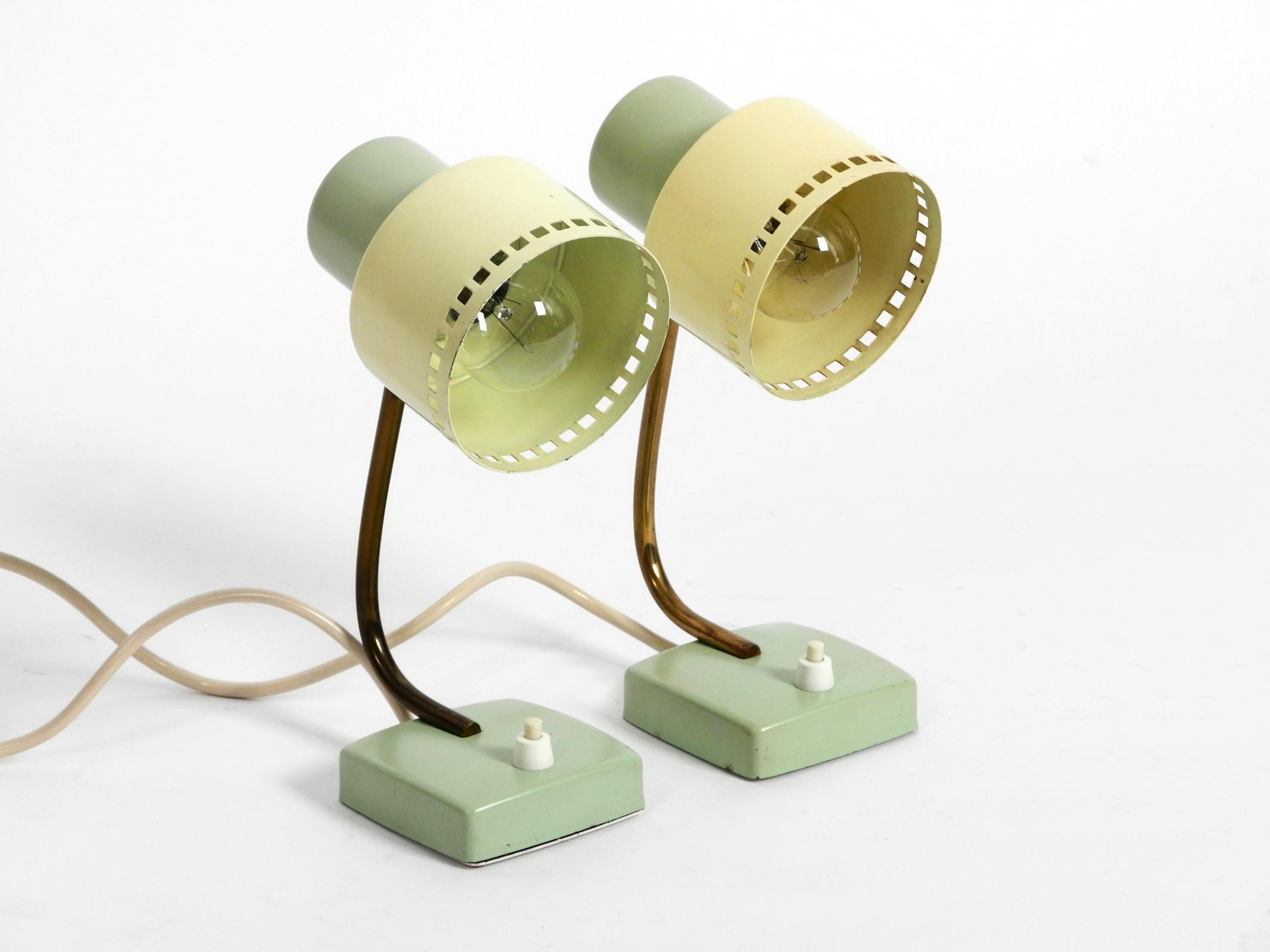 Two beautiful midcentury metal night or desk lamps.
Fantastic in this combination of mint green and yellow.
Typical design from that time, in very good vintage condition.
Shades can be adjusted continuously in height.
Shades and feet are made of