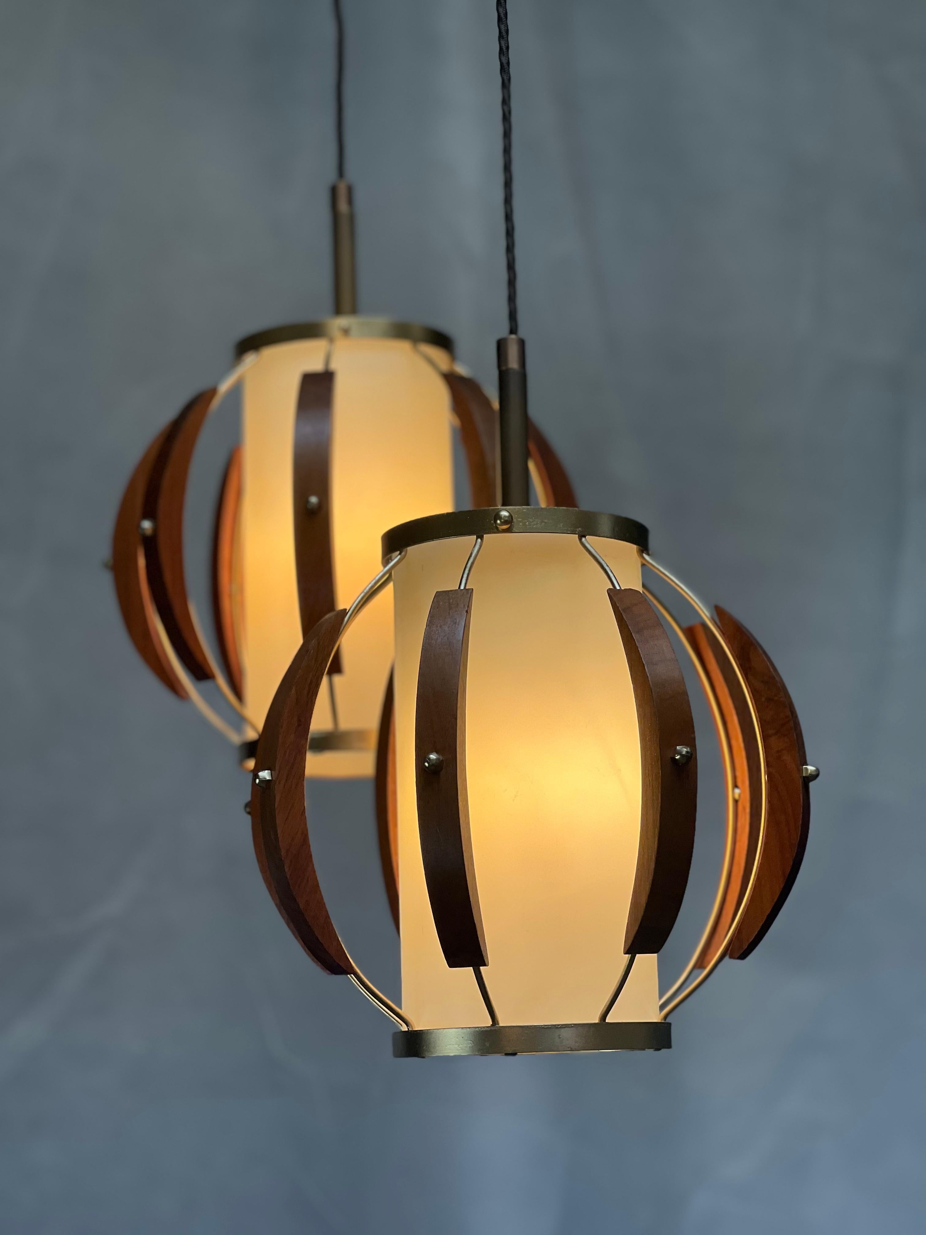 Stunning original pair of MCM, Mid-Century Modern pendant lights that have been fully rewired, tip to toe, with UL certified parts by a restoration specialist. Your restaurant has an electrical inspector? These will pass with flying colors.
Wood is