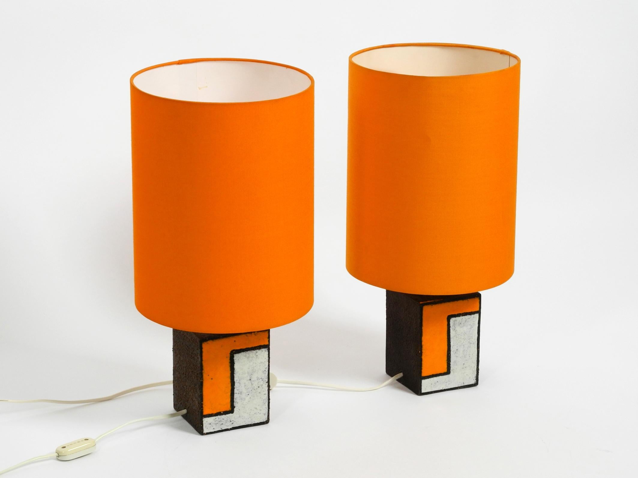 Two very nice 1950s ceramic table lamps with round orange fabric shades.
Great mid century design from Italy. Both with labels 