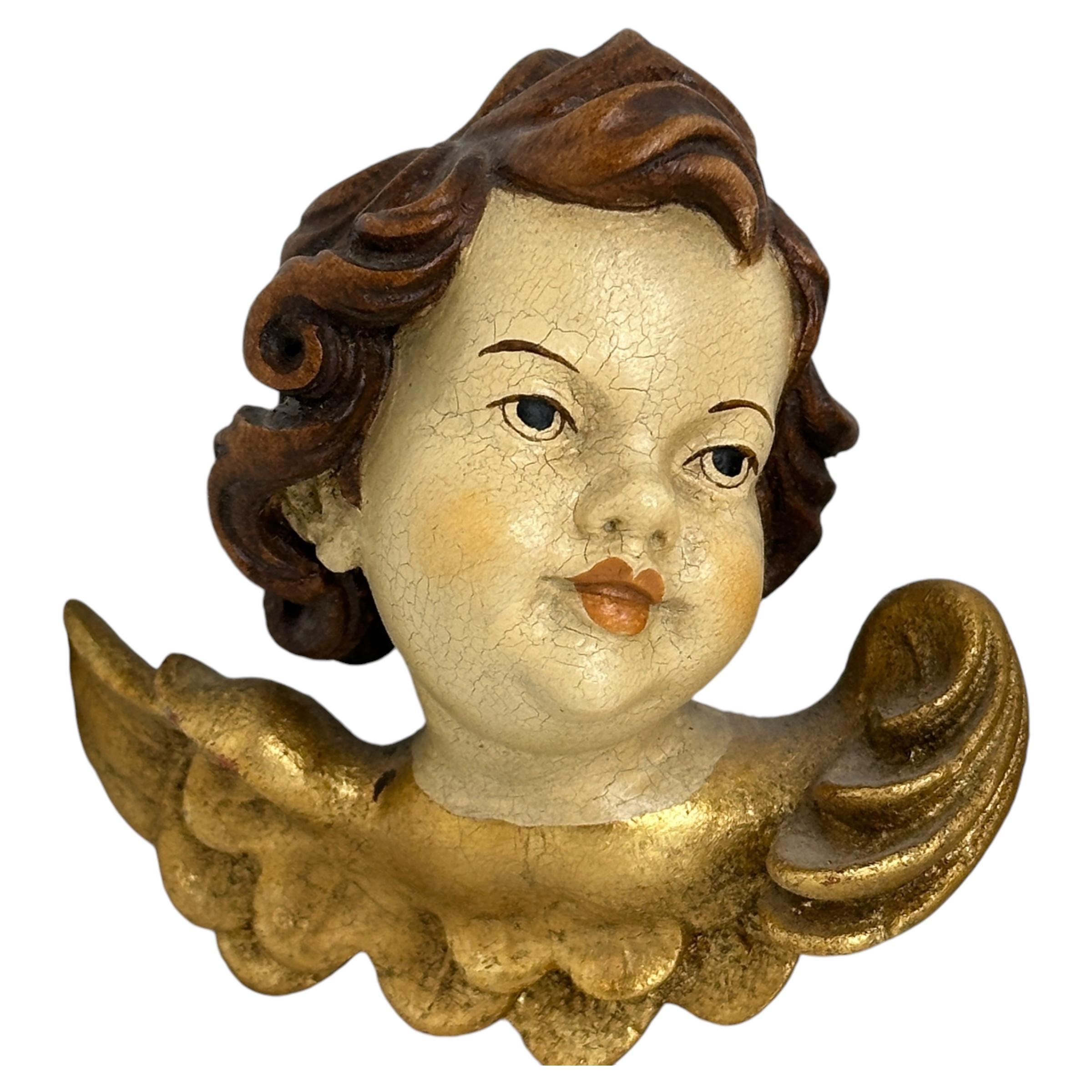 A pair beautiful hand carved and hand painted cherub angel Heads, found at an estate sale in Nuremberg, Germany. Made by a woodcarver in the Oberammergau area, this area is well-known for their wood carvings. The size given in the dimensions section