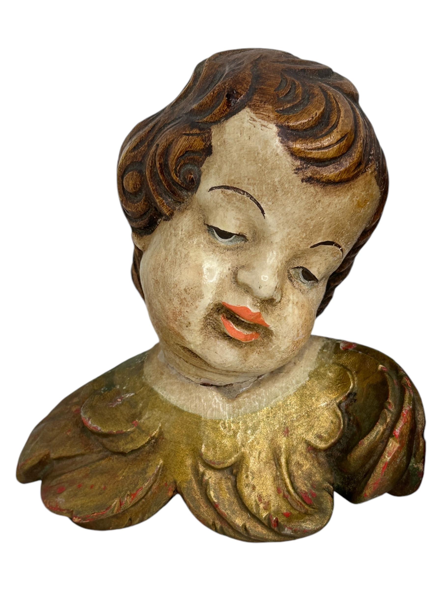 A pair beautiful hand carved and hand painted cherub angel Heads, found at an estate sale in Nuremberg, Germany. Made by a woodcarver in the Oberammergau area, this area is well-known for their wood carvings. The size given in the dimensions section