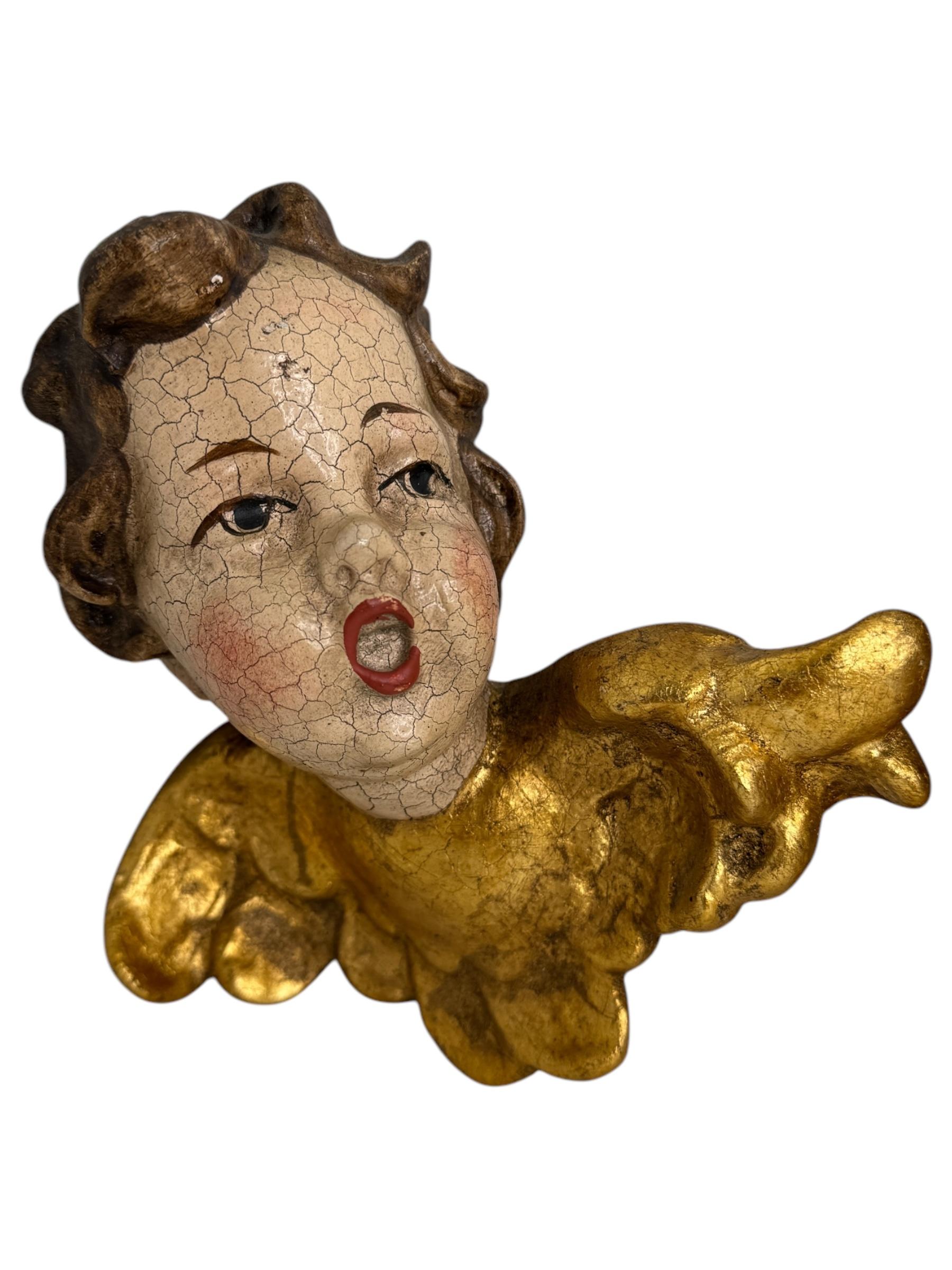 A pair beautiful hand carved and hand painted cherub angel Heads, found at an estate sale in Nuremberg, Germany. Made by a woodcarver in the Oberammergau area, this area is well-known for their wood carvings. The size given in the dimensions section