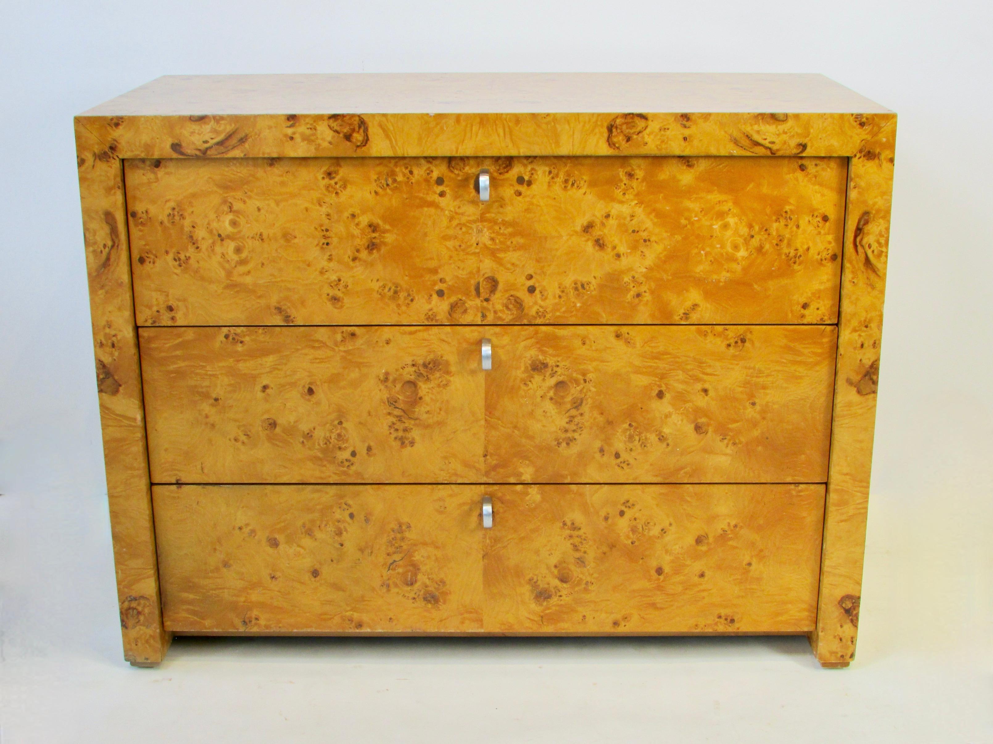 Pair of three drawer cabinets covered in blonde burl. Each drawer having a single chrome center pull. Patina to the finish but no damage or apologies. Stamped Hekman inside drawer of one cabinet.