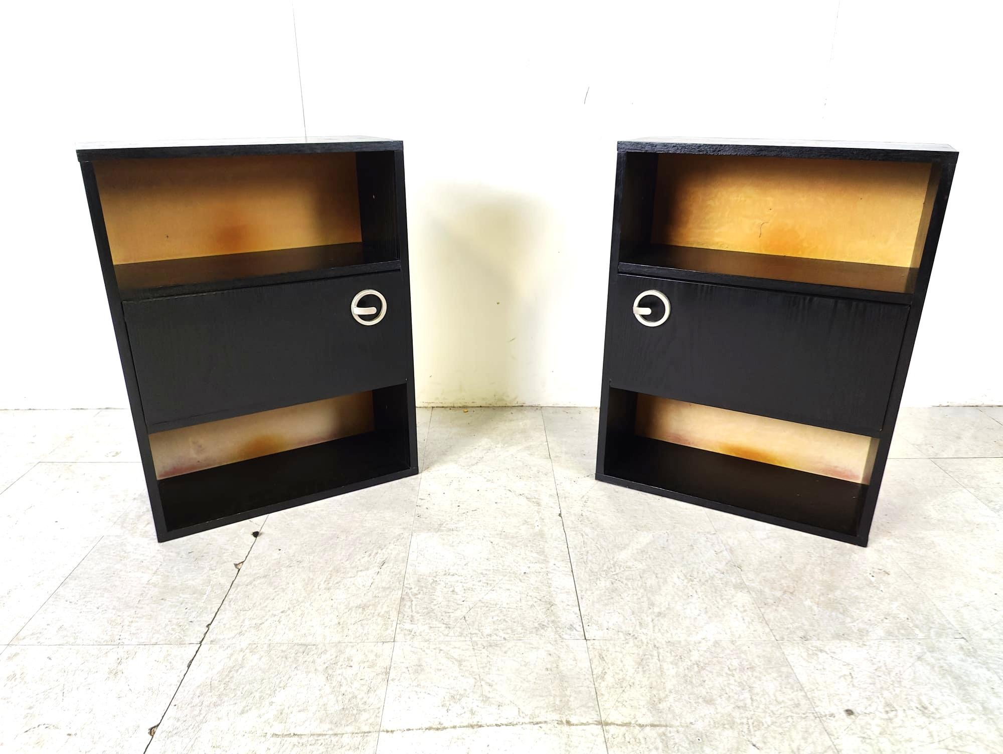 Pair of black wooden seventies bedside cabinets.

The cabinets have cool handles. 

1970s - Belgium

Good condition

Dimensions:
Height: 73cm
Width: 55cm
Depth: 25cm

Ref.: 6425152