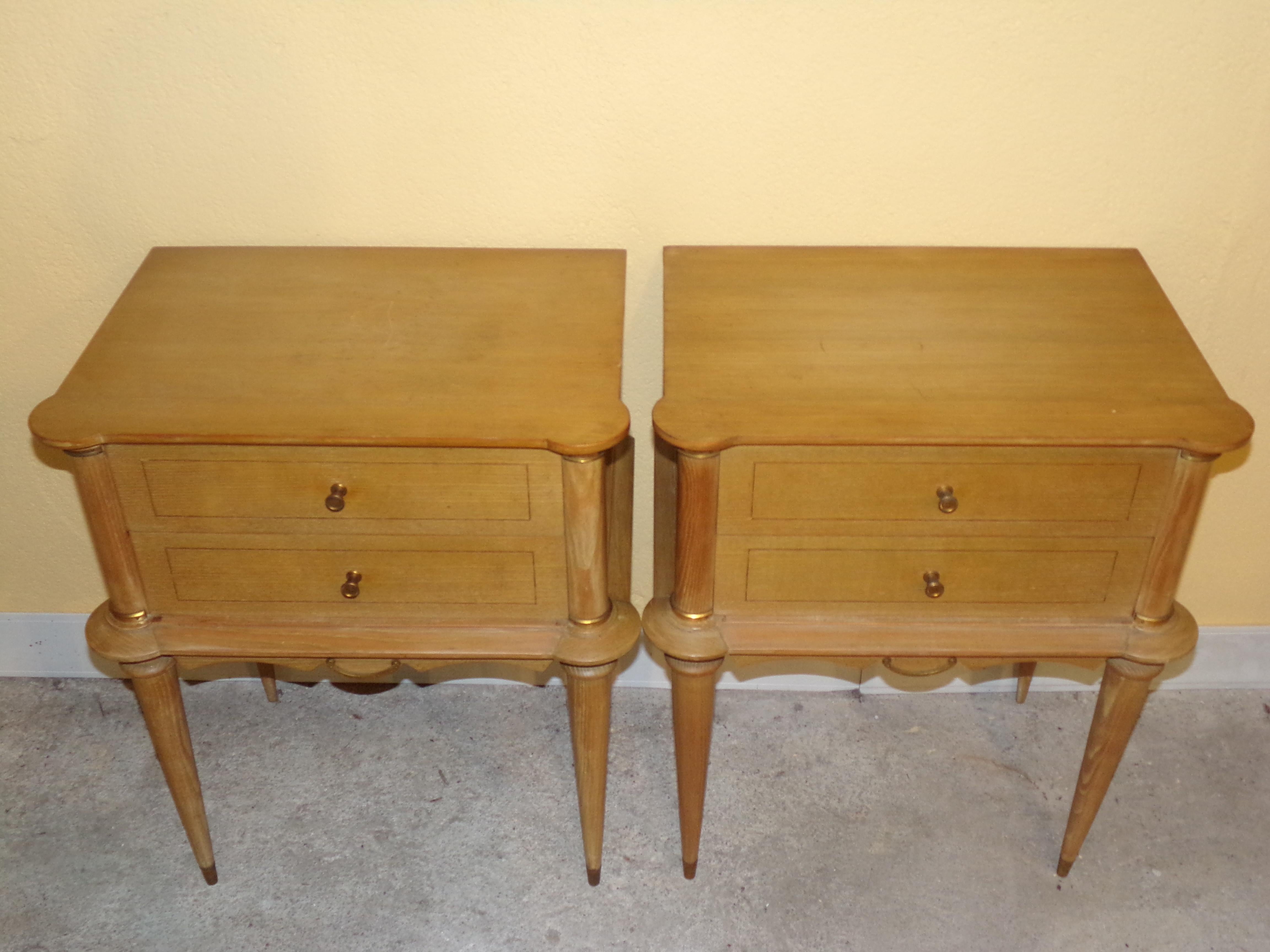 A good pair of mid last century quality bedside cabinets in bleached beechwood with gilt mounts.