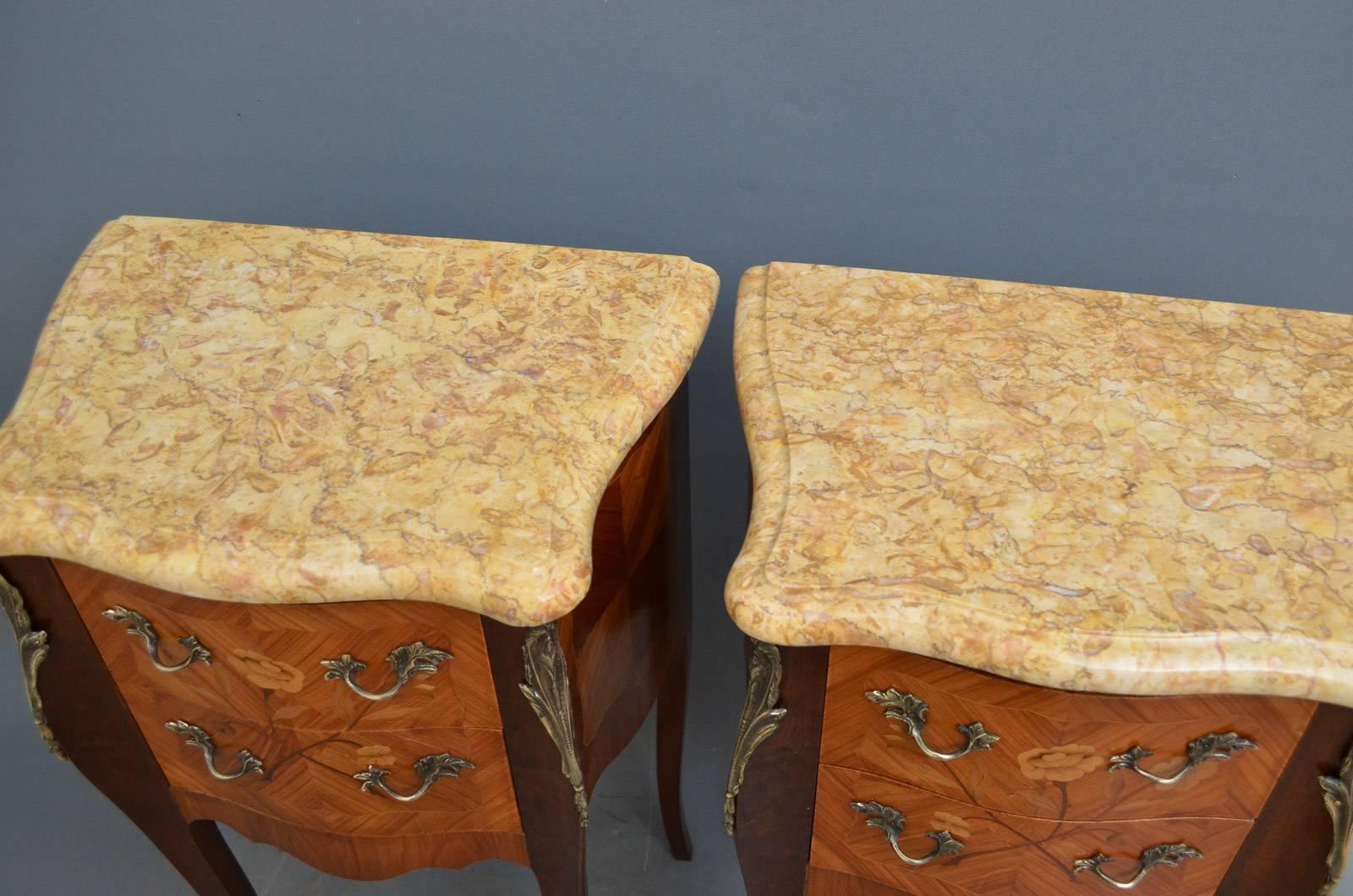 Sn3693, a pair of tulipwood night tables, having serpentine marble tops above two flower inlaid drawers fitted with original brass handles and flanked by ormolu decoration, all standing on slender cabriole legs with brass sabots. This antique pair