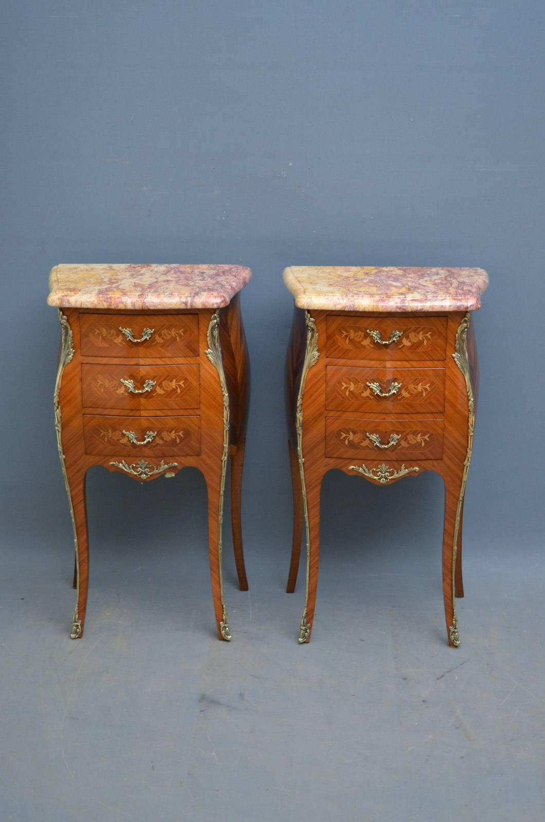 Sn4320 pair of French tulipwood night tables, having serpentine marble tops above three flower inlaid drawers fitted with original brass handles, and flanked by ormolu decoration from top to bottom and shaped, string inlaid sides, all standing on