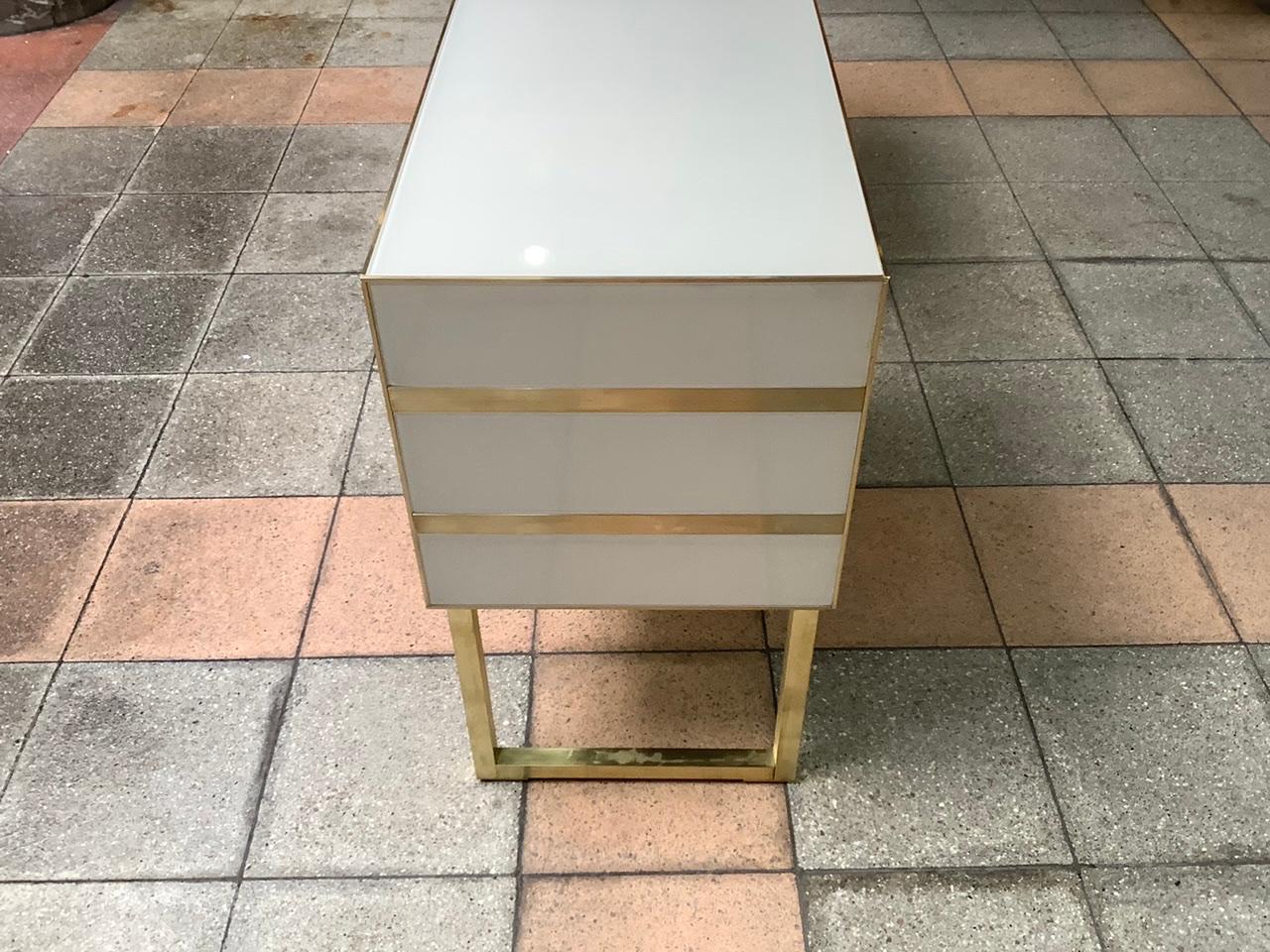 Pair of bedside in tinted glass and brass with two drawers. Only on model signed « Martin studio « for Justine.
