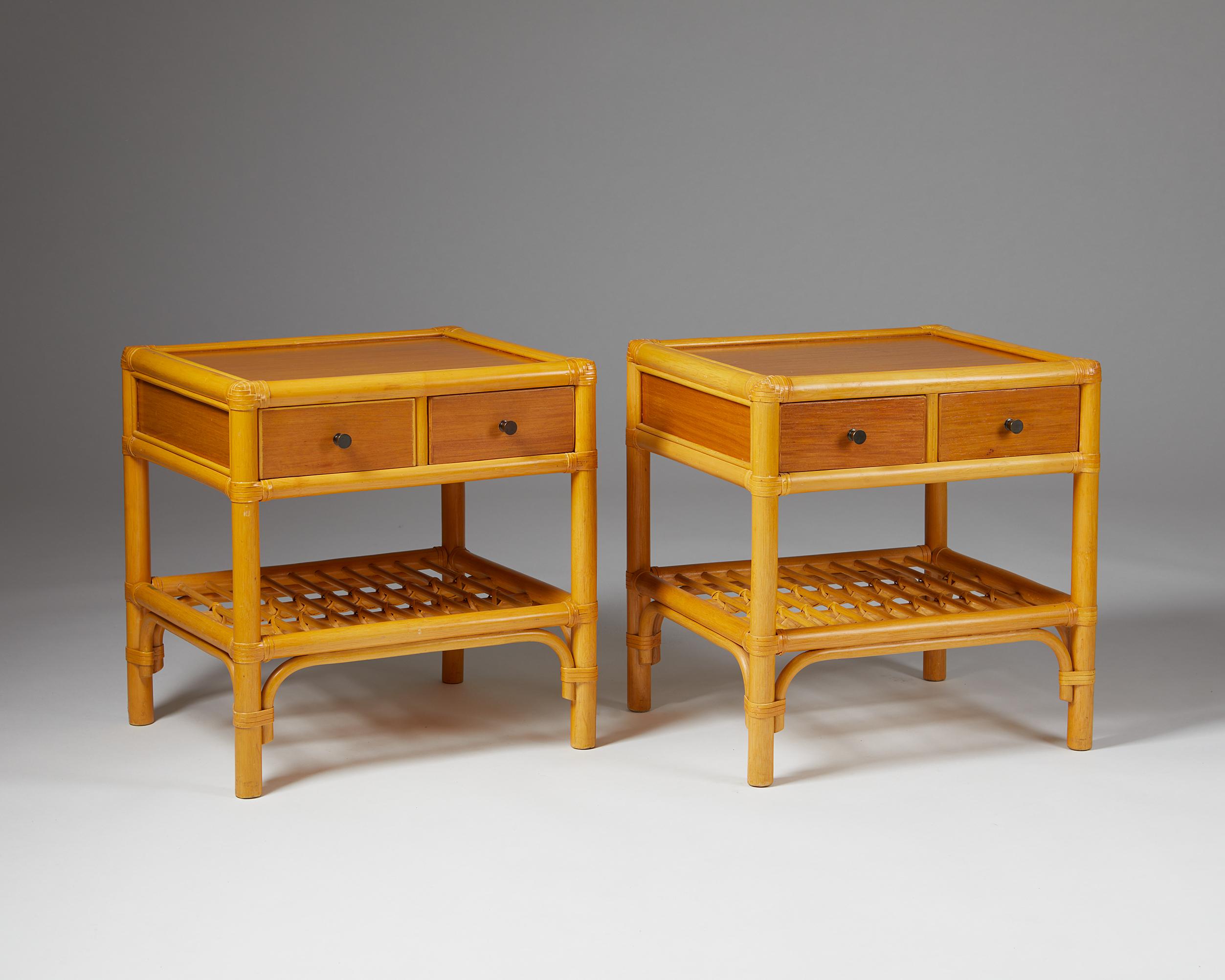 Pair of bedside tables, anonymous for DUX,
Sweden. 1960s.

Cane, rattan and teak.

The colonial-style combination of cane, rattan, and teak makes this Scandinavian bedside table design particularly interesting. The woven edges and metal handles